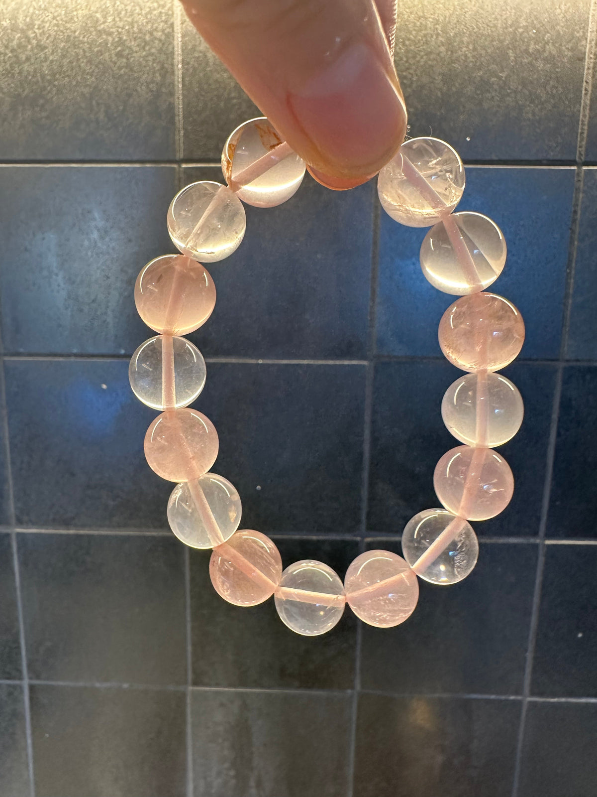Mozambique Rose Quartz stretch bracelet with polished pink beads, featured in a Christmas necklace and bracelet pairing guide