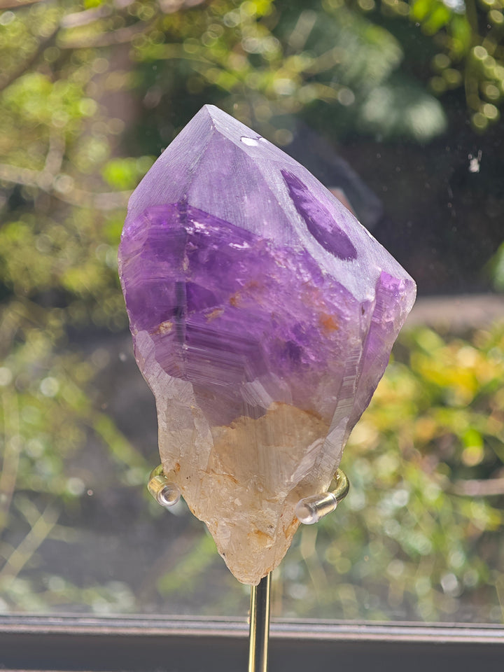 Natural raw Brazilian Amethyst point with purple crystal faces
