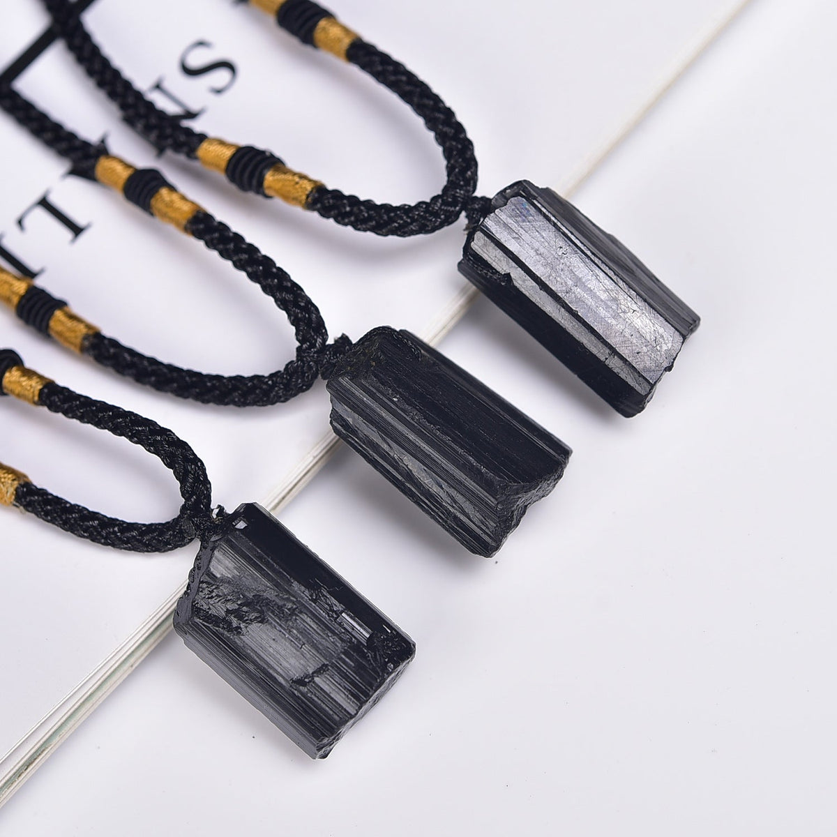 Raw black tourmaline crystal pendant necklaces with ridged natural texture and black cords