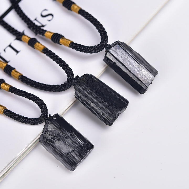 Raw black tourmaline crystal pendant necklaces with ridged natural texture and black cords
