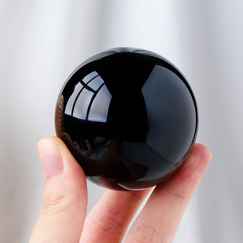 Polished black obsidian sphere for protection collection