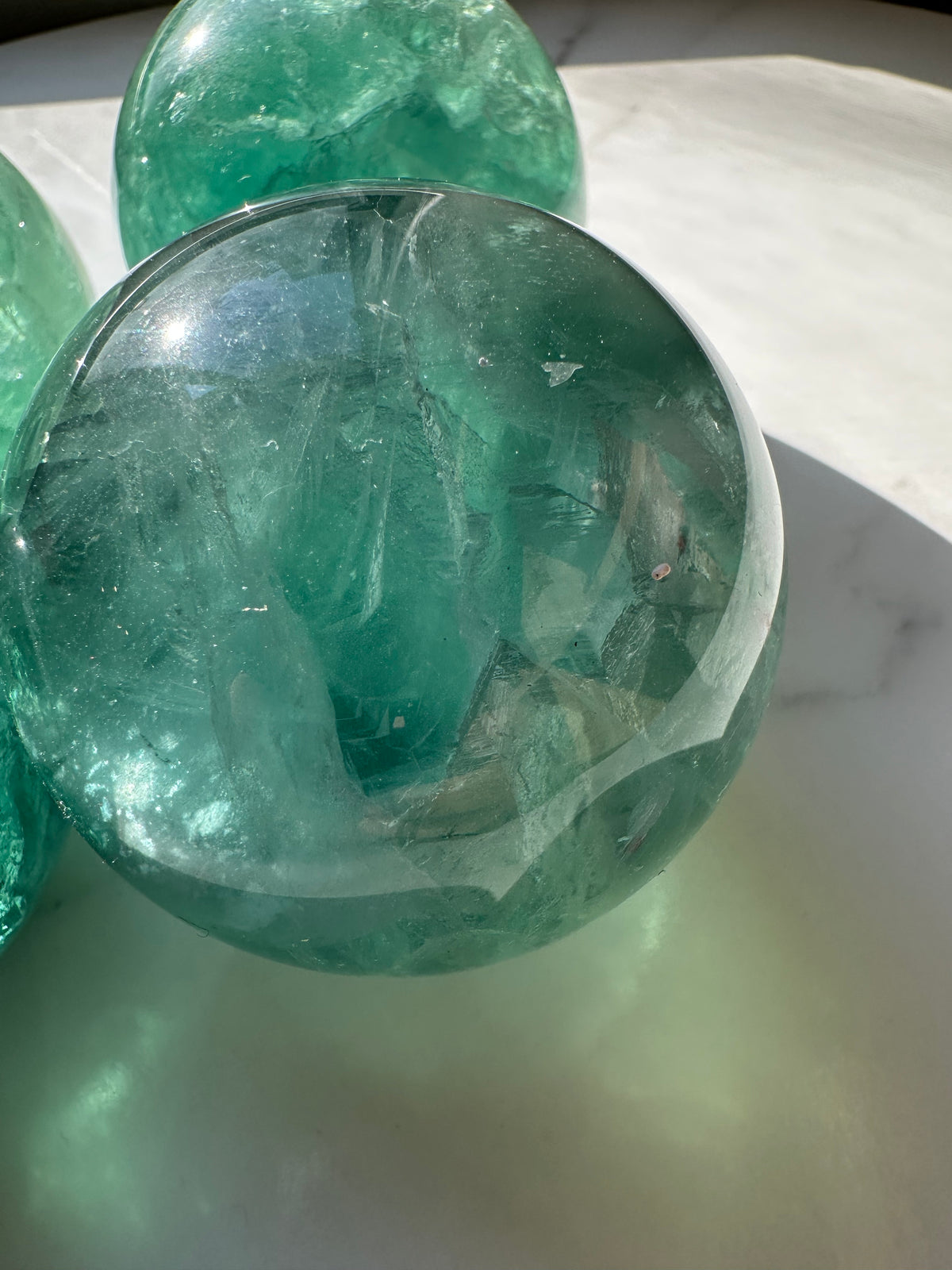 Polished Green Fluorite sphere detail with translucent green layers