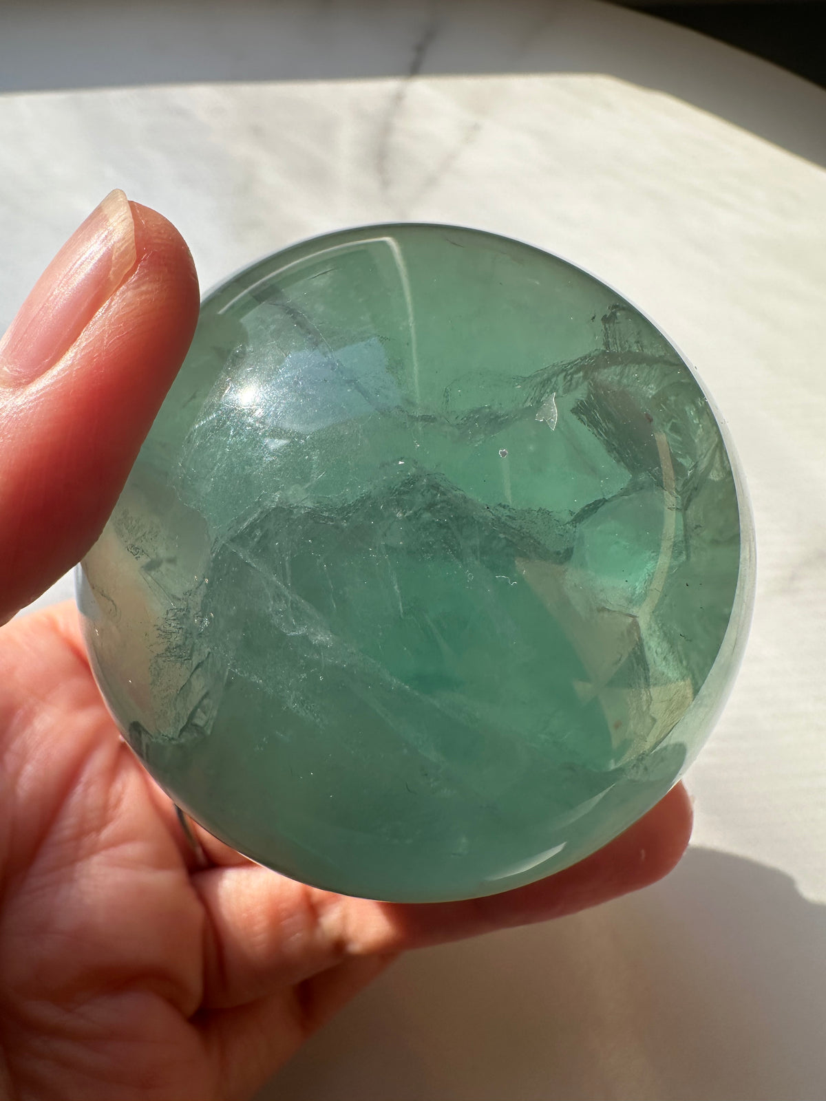 Green Fluorite sphere close-up showing natural inclusions and zoning