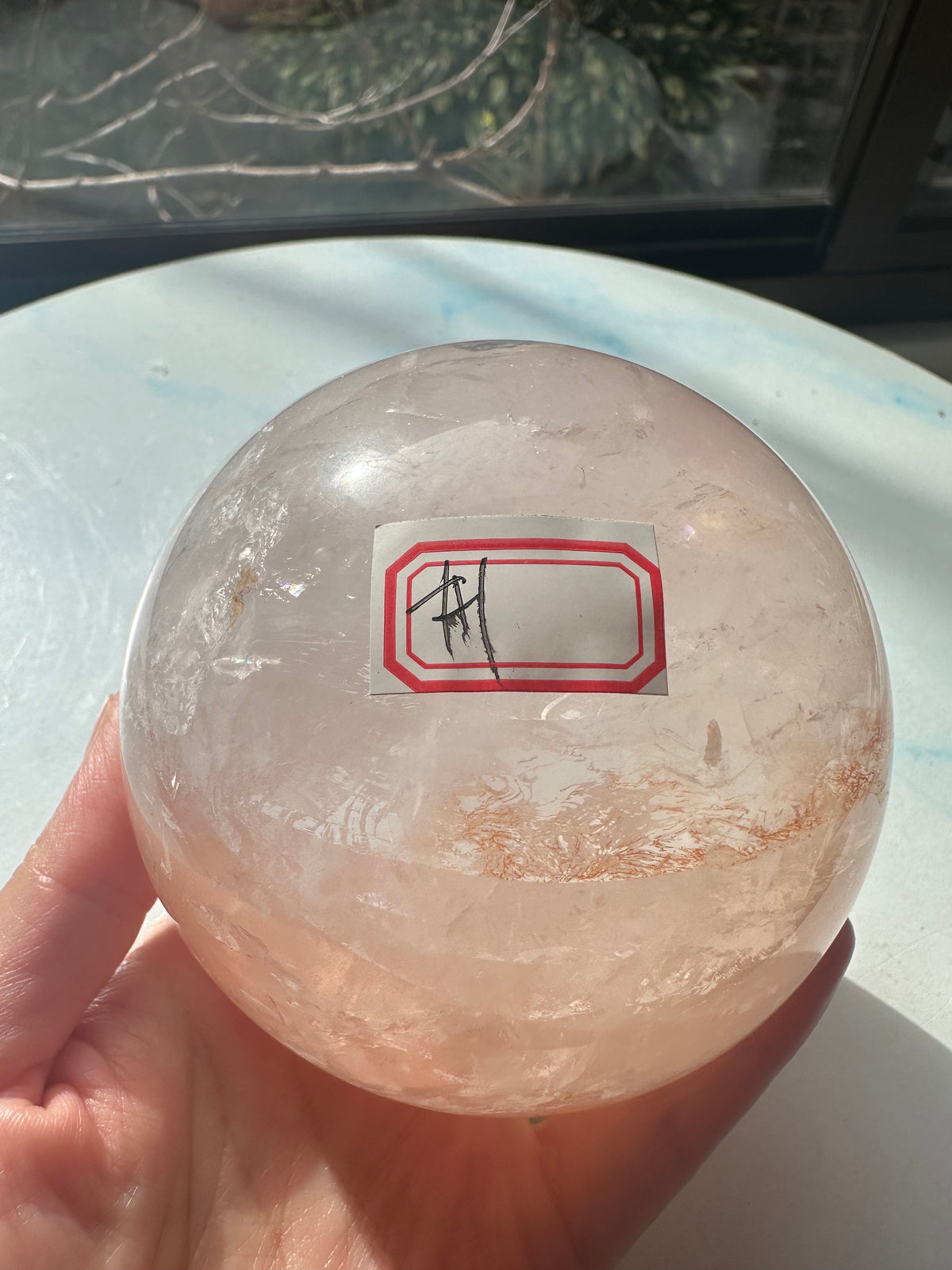 Fire Quartz sphere #1 showing red hematite inclusions and internal quartz veils, alternate view 3