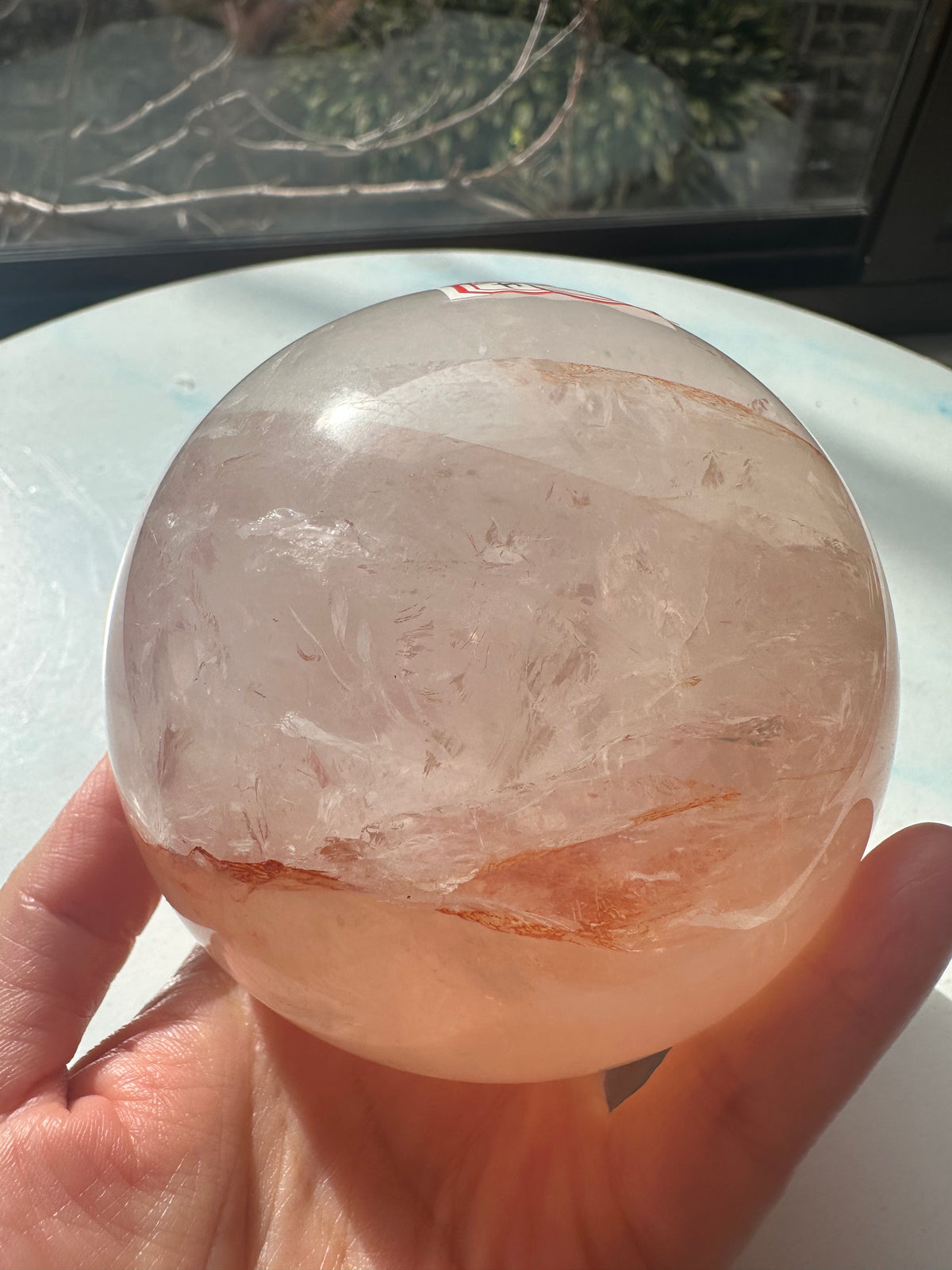 Fire Quartz sphere #1 showing red hematite inclusions and internal quartz veils, alternate view 4