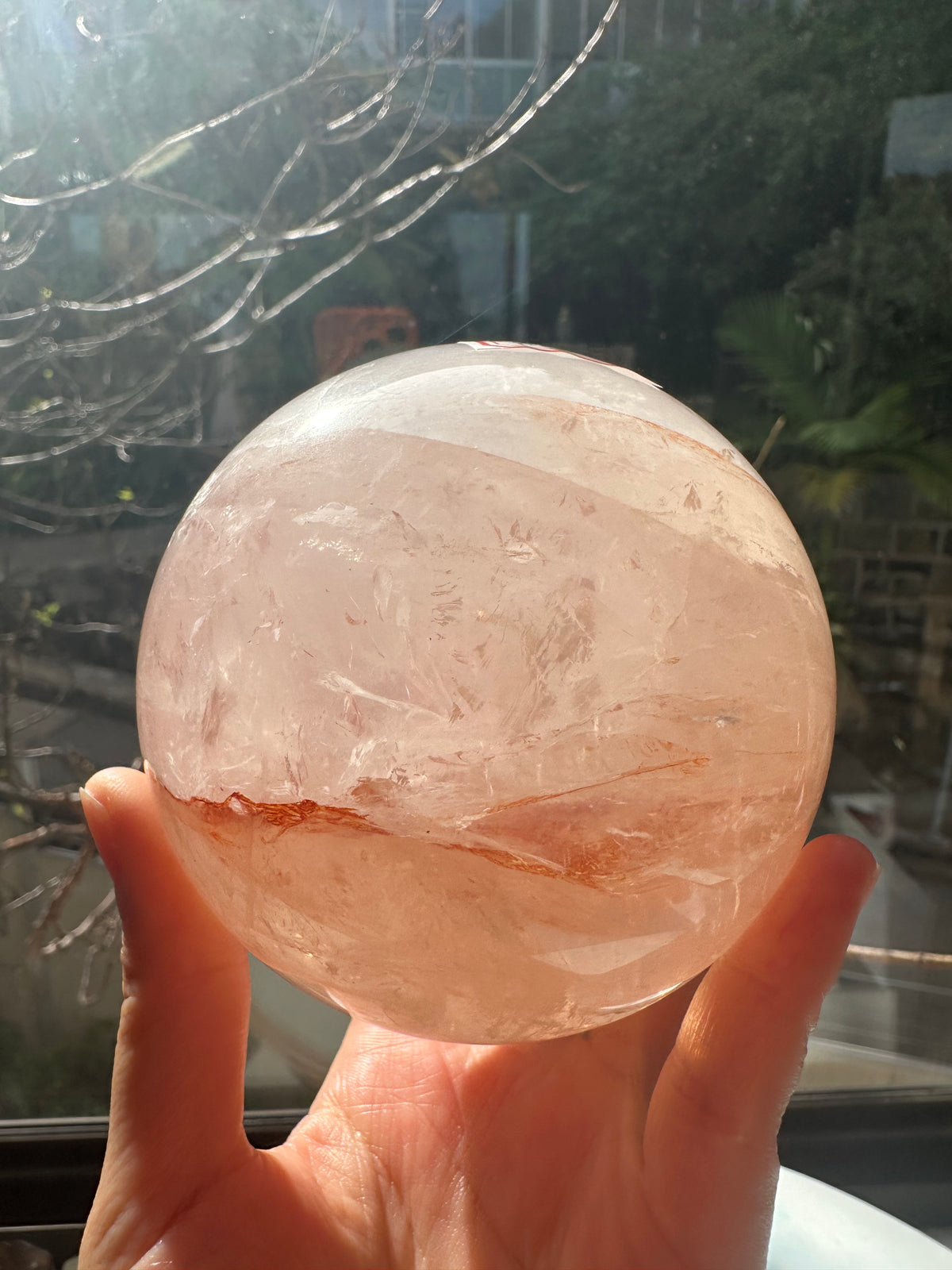 Fire Quartz sphere #1 showing red hematite inclusions and internal quartz veils, alternate view 5