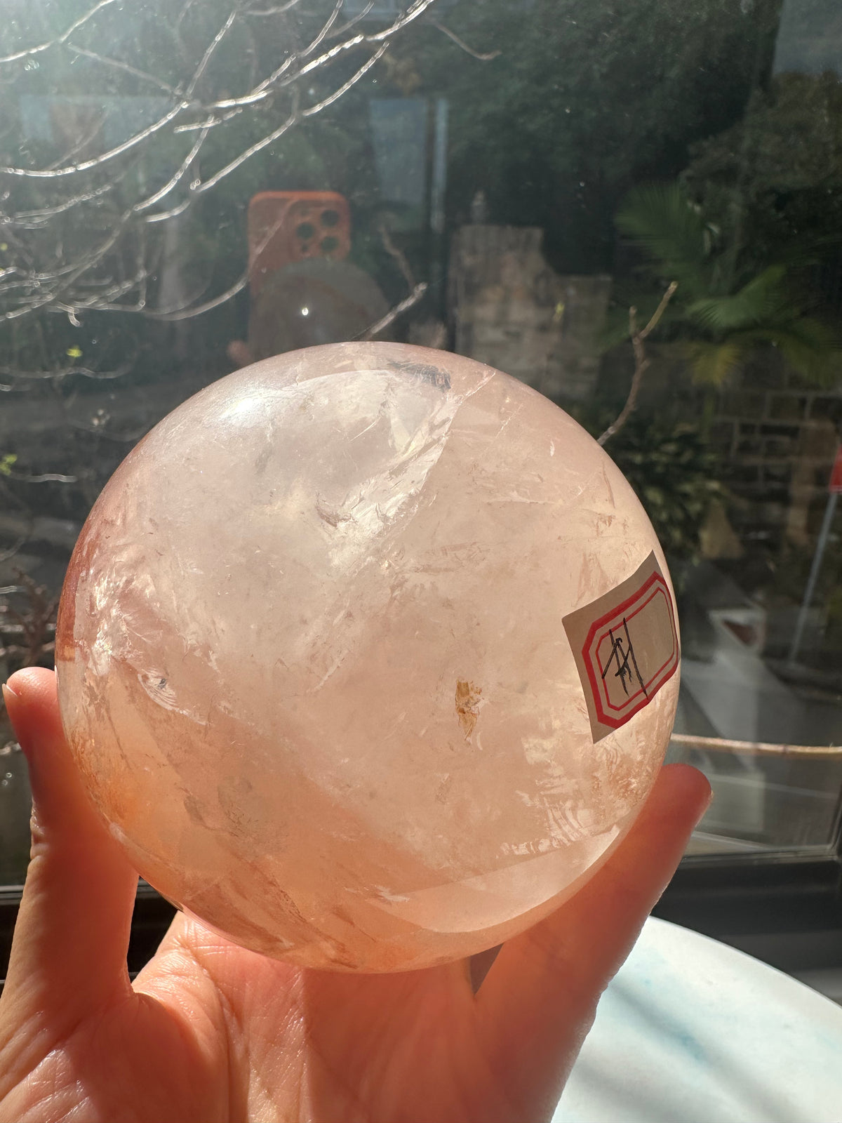 Fire Quartz sphere #1 showing red hematite inclusions and internal quartz veils, alternate view 6