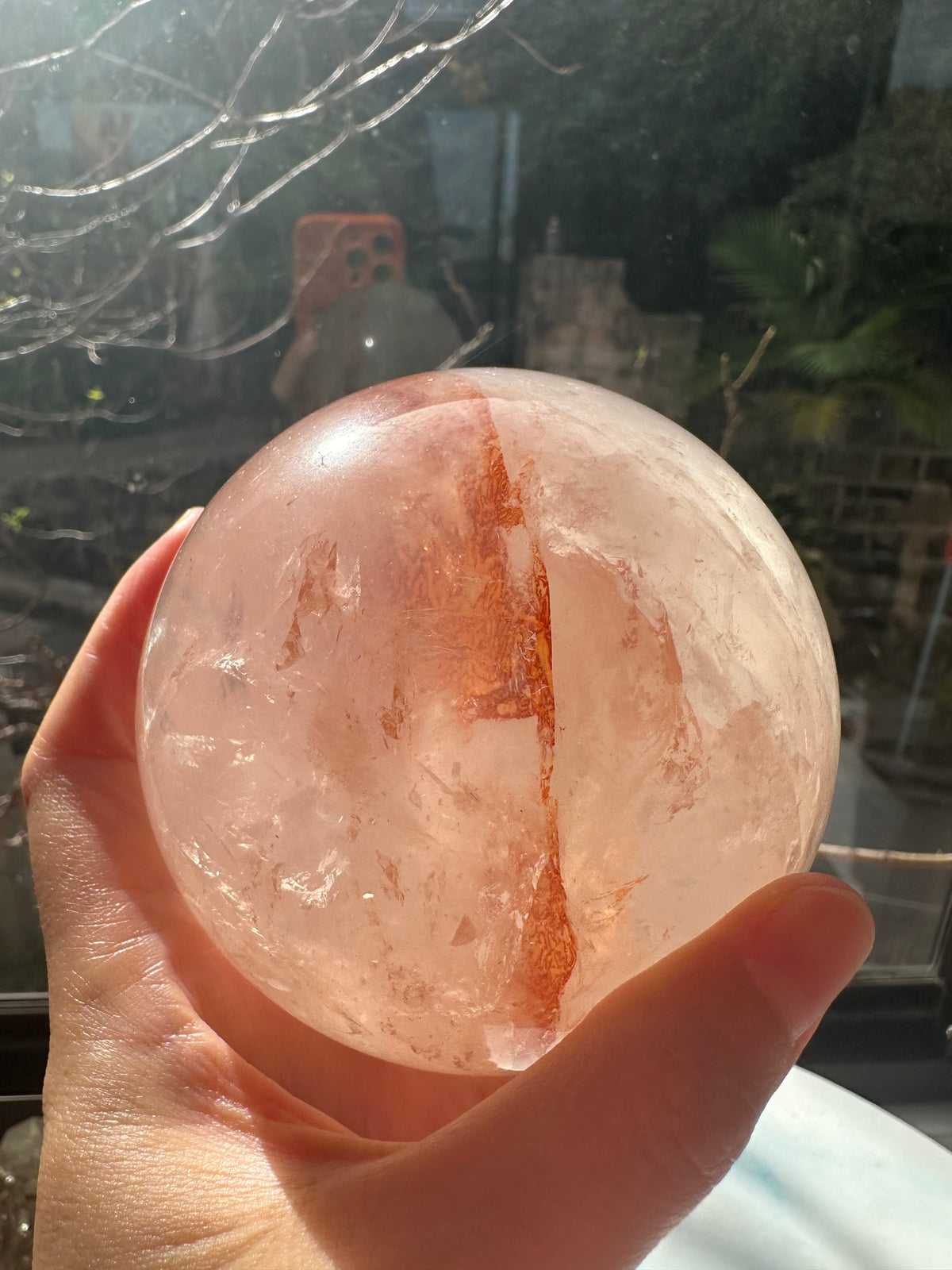 Fire Quartz sphere #1 showing red hematite inclusions and internal quartz veils, alternate view 7