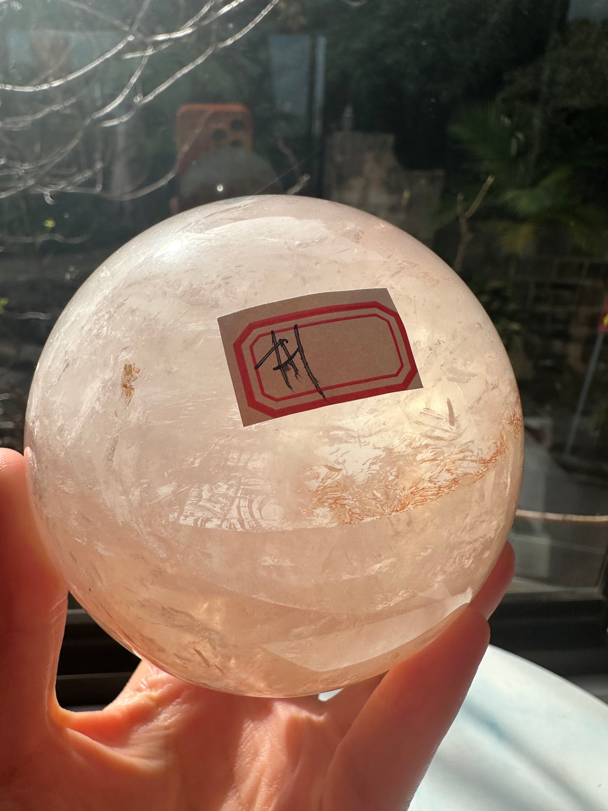 Fire Quartz sphere #1 showing red hematite inclusions and internal quartz veils, alternate view 8