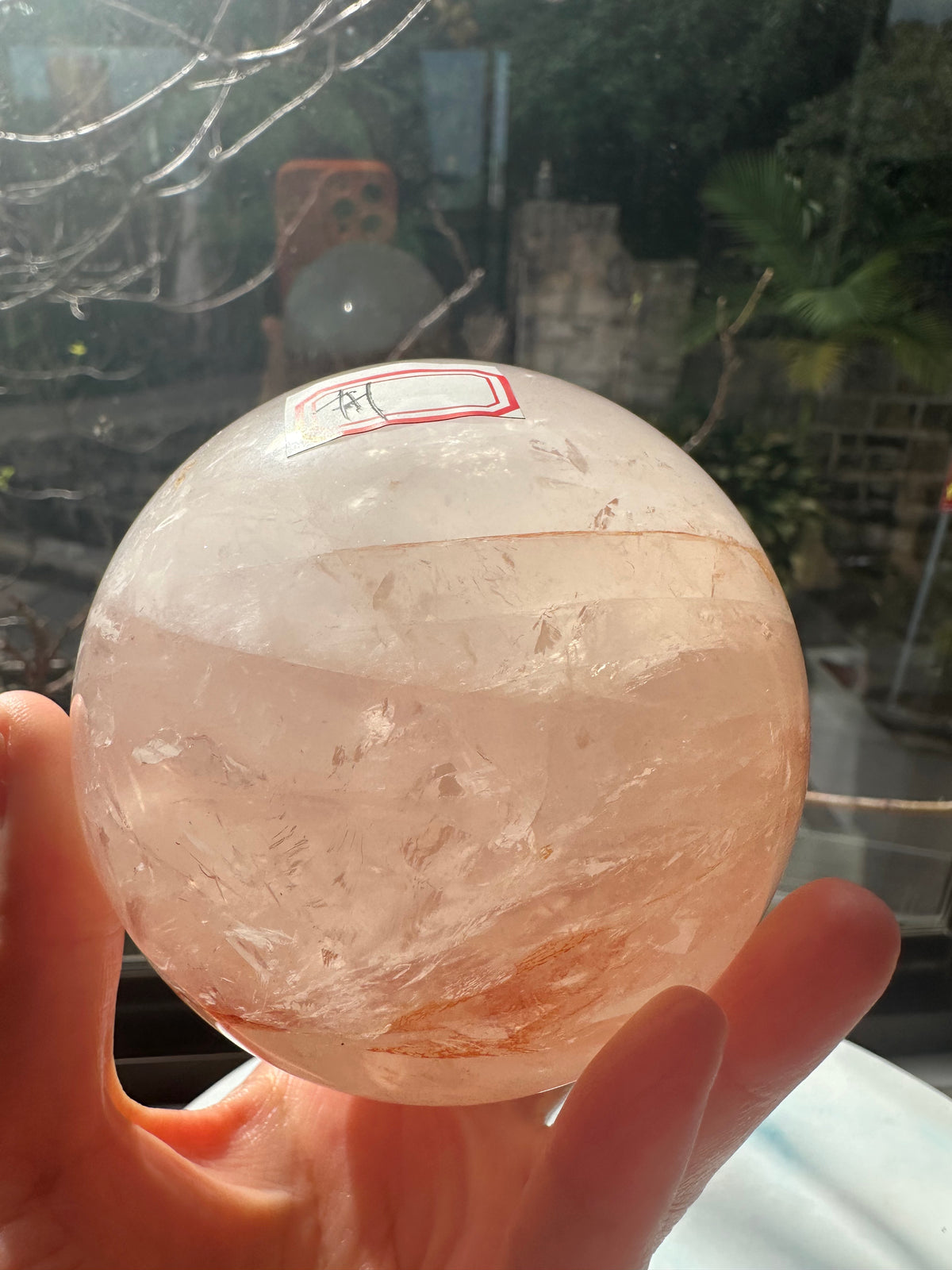 Fire Quartz sphere #1 showing red hematite inclusions and internal quartz veils, alternate view 9