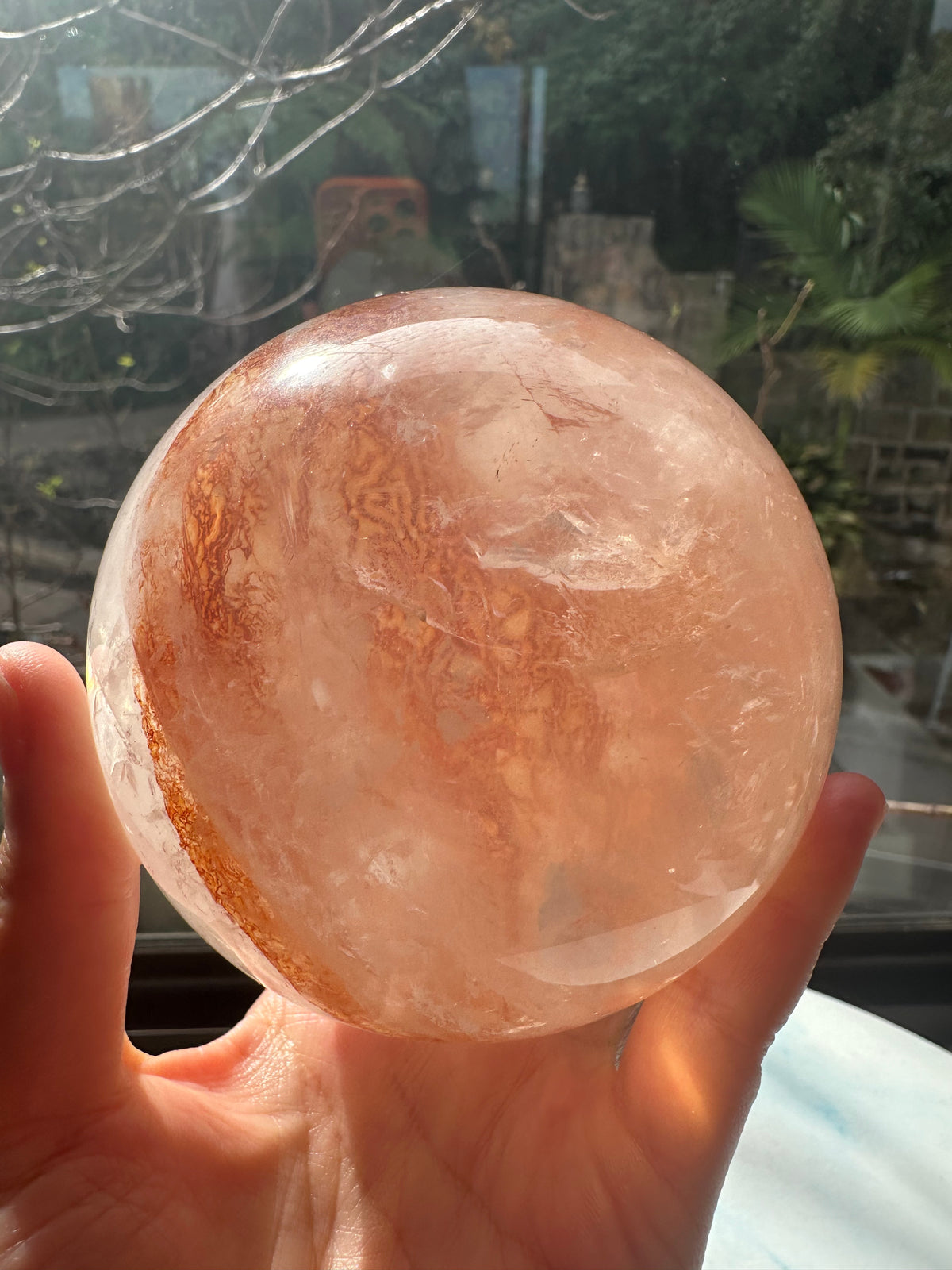 Fire Quartz sphere #1 showing red hematite inclusions and internal quartz veils, alternate view 11