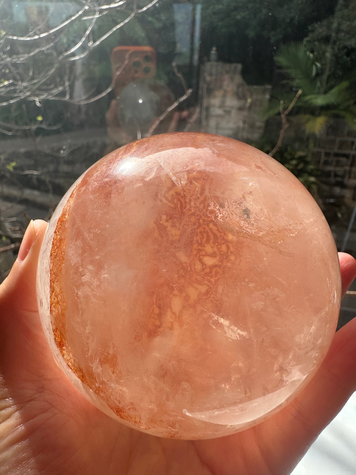 Fire Quartz sphere #1 showing red hematite inclusions and internal quartz veils, alternate view 2