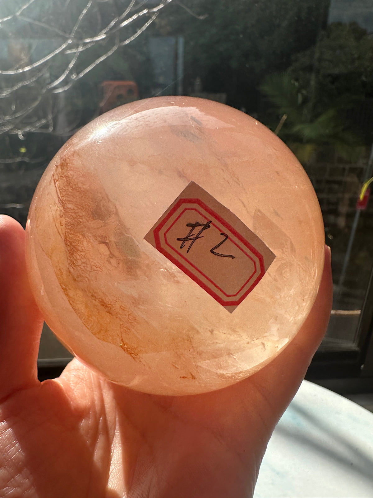 Fire Quartz sphere #2 showing red hematite inclusions and internal quartz veils, alternate view 3
