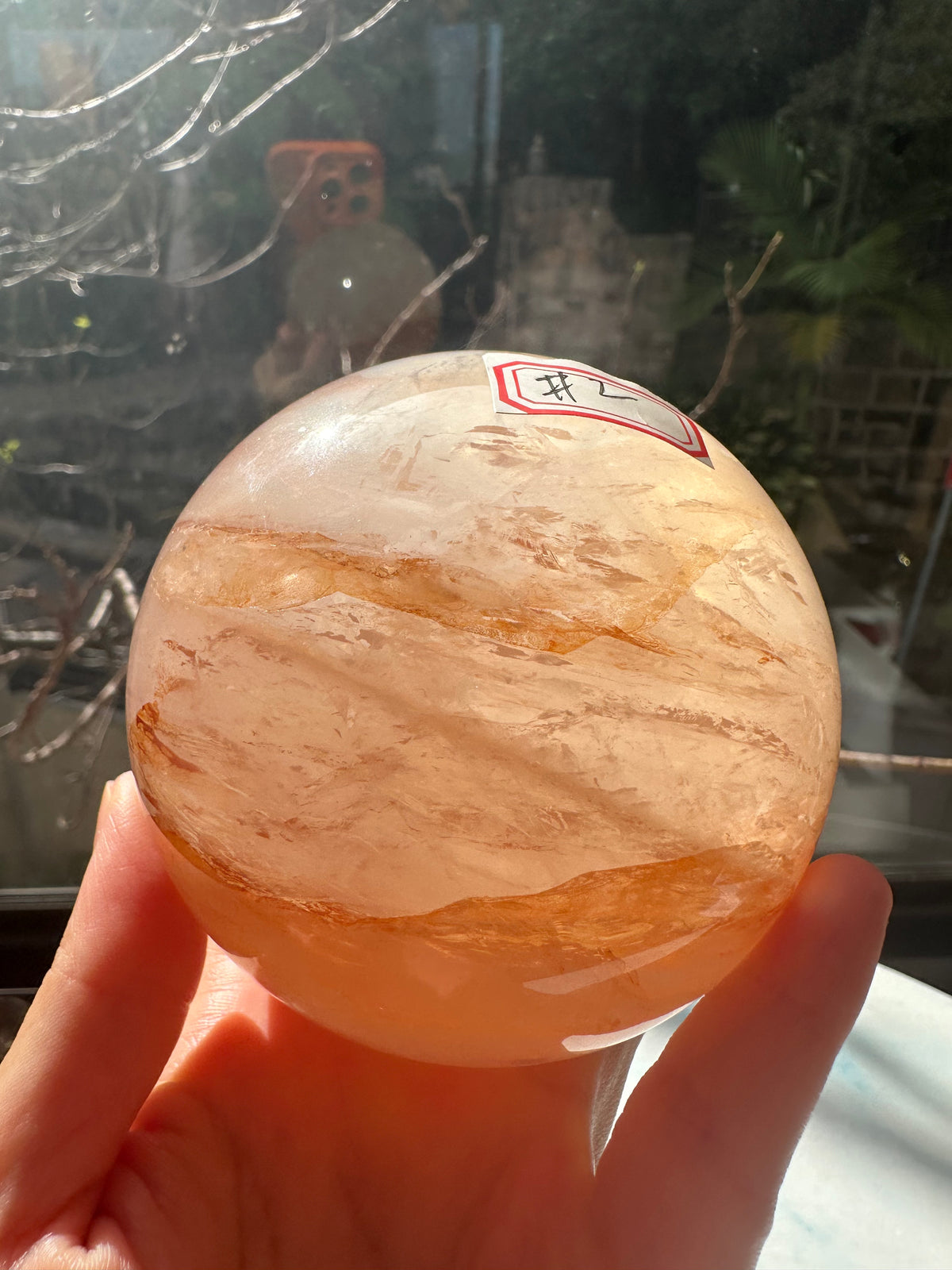 Fire Quartz sphere #2 showing red hematite inclusions and internal quartz veils, alternate view 4