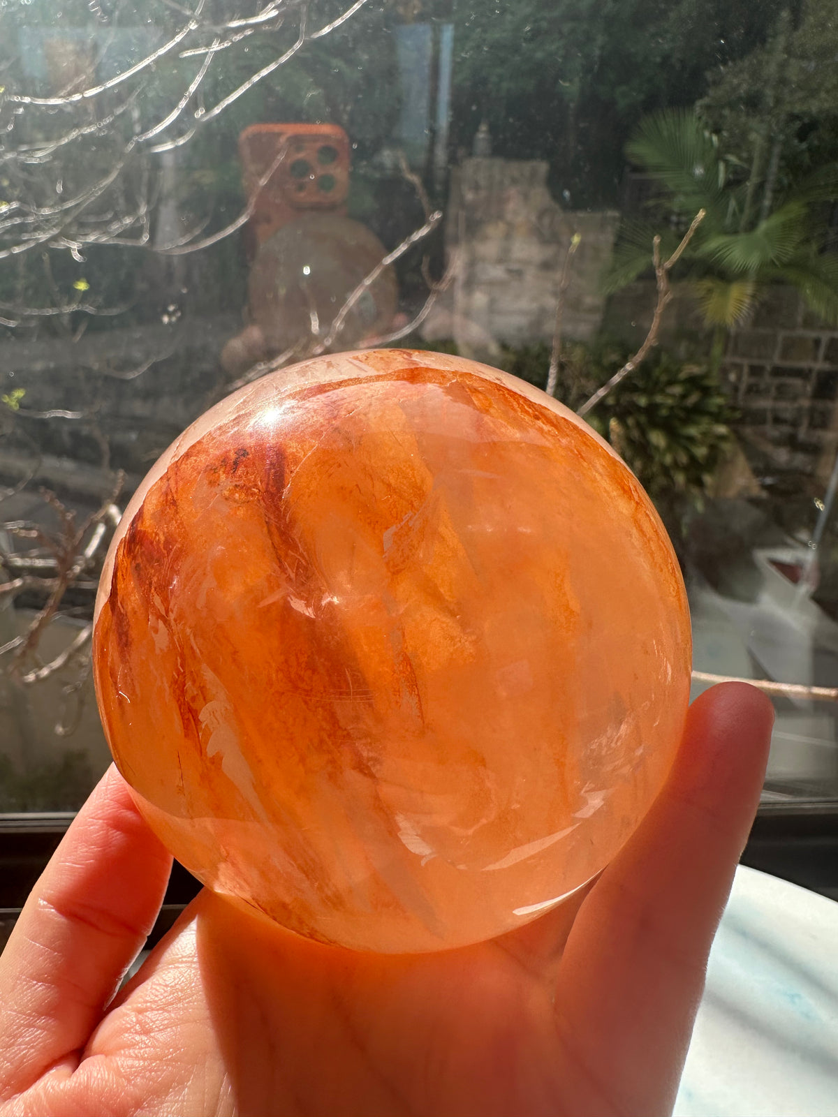 Fire Quartz sphere #2 showing red hematite inclusions and internal quartz veils, alternate view 5