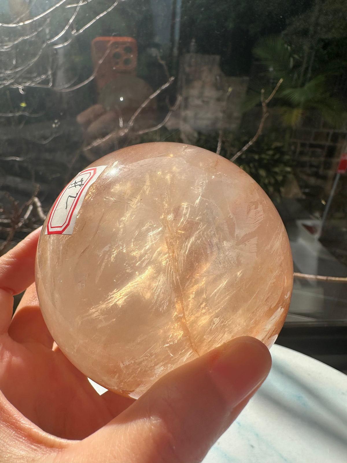 Fire Quartz sphere #2 showing red hematite inclusions and internal quartz veils, alternate view 7