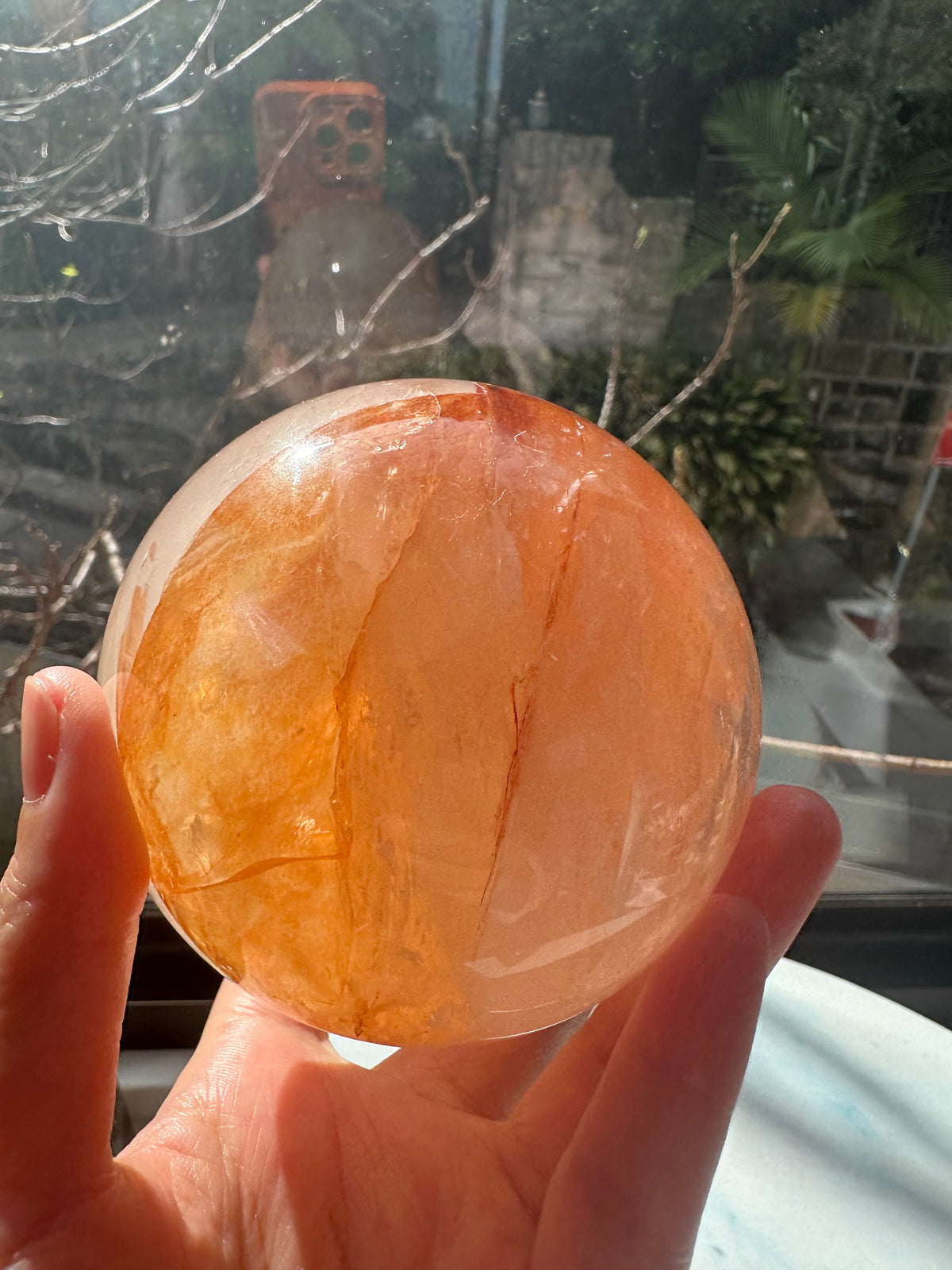 Fire Quartz sphere #2 showing red hematite inclusions and internal quartz veils, alternate view 10