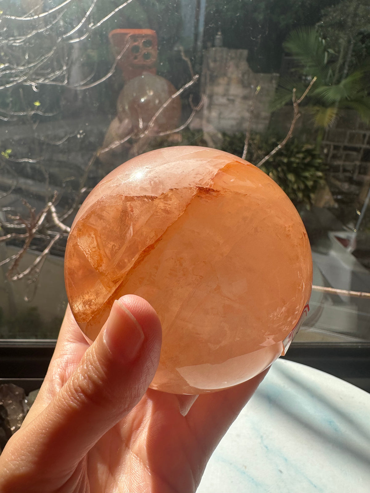 Fire Quartz sphere #2 showing red hematite inclusions and internal quartz veils, alternate view 13