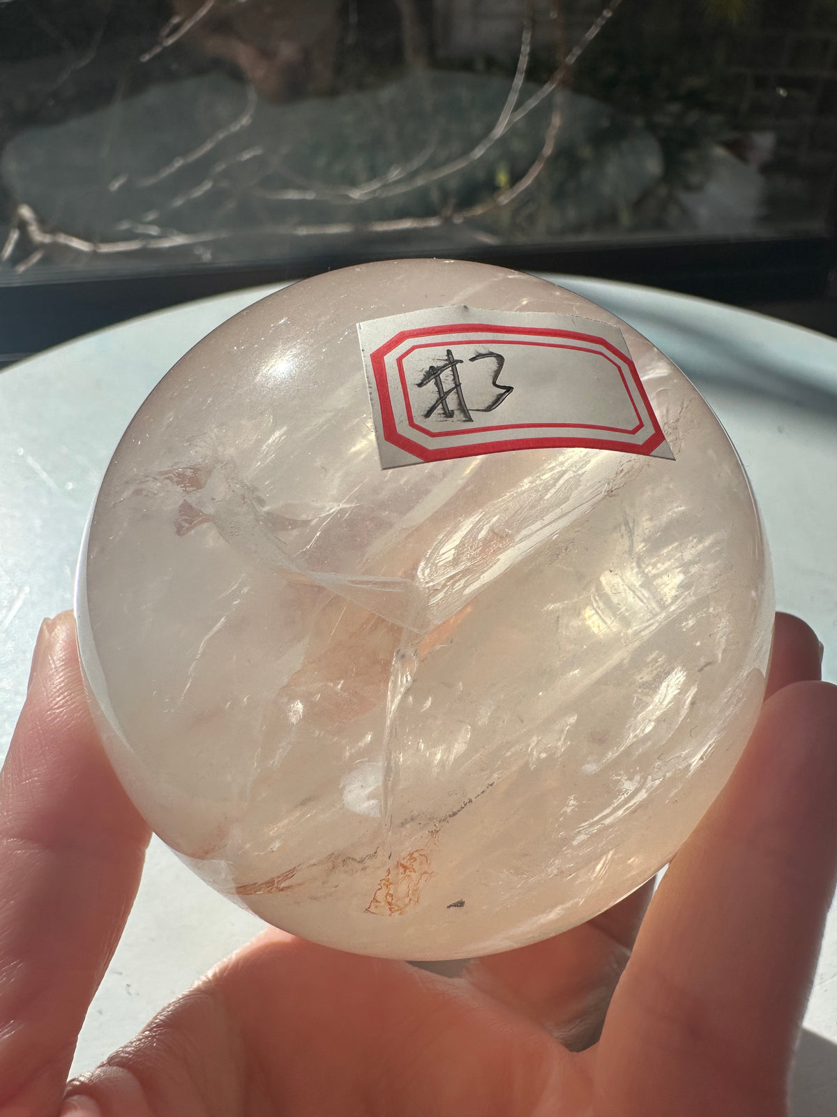 Fire Quartz sphere #3 showing red hematite inclusions and internal quartz veils, alternate view 2