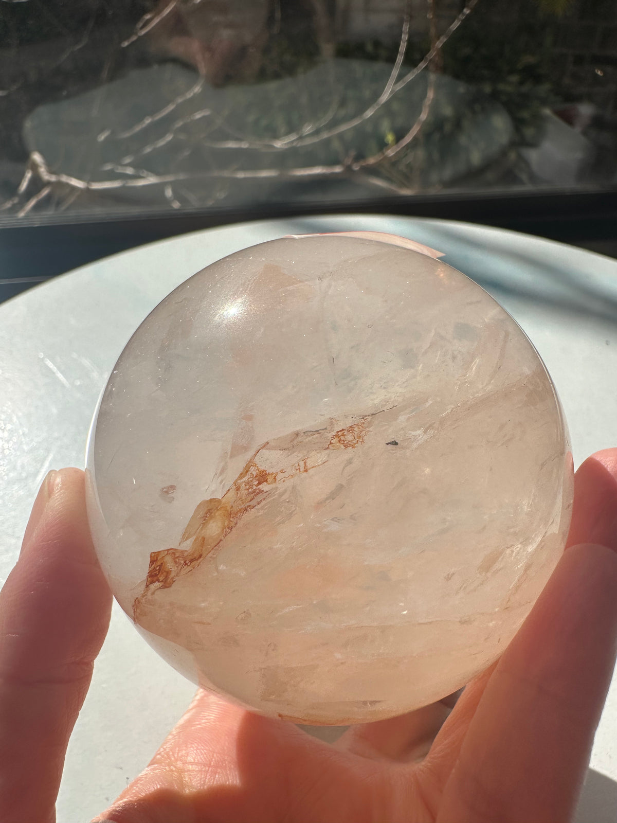 Fire Quartz sphere #3 showing red hematite inclusions and internal quartz veils, alternate view 3