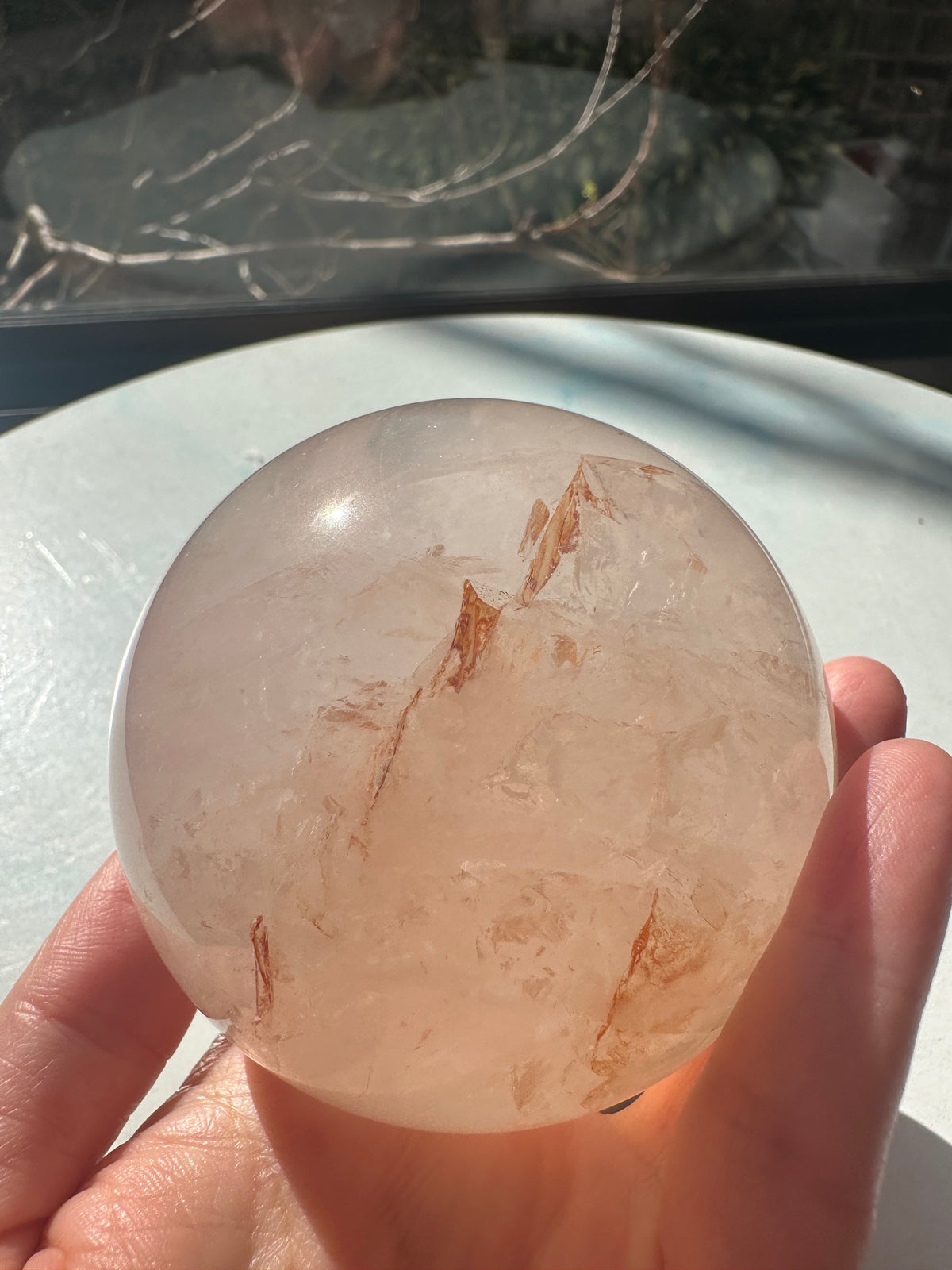Fire Quartz sphere #3 showing red hematite inclusions and internal quartz veils, alternate view 4