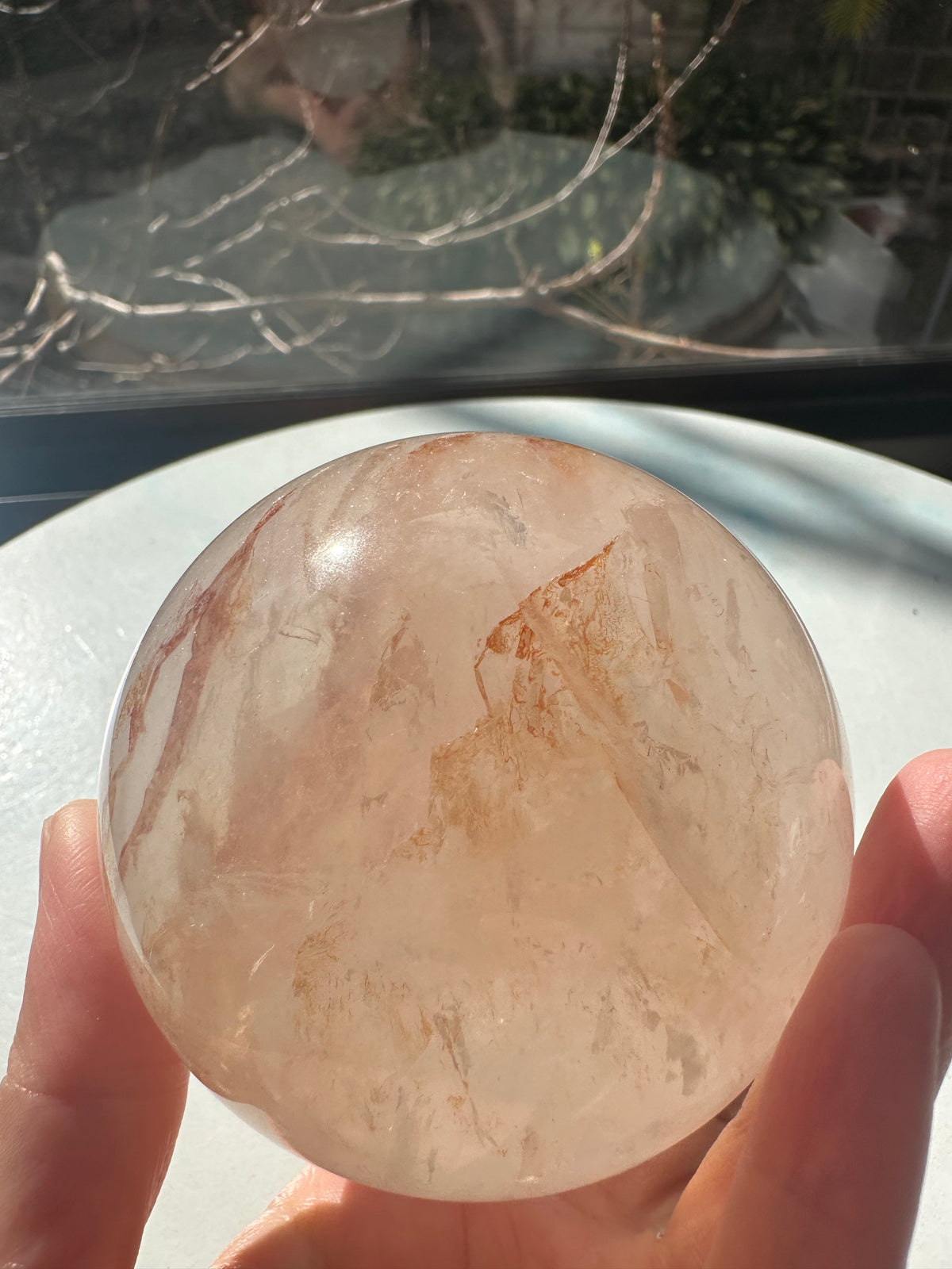 Fire Quartz sphere #3 showing red hematite inclusions and internal quartz veils, alternate view 5