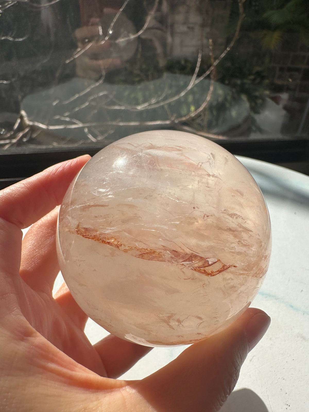 Fire Quartz sphere #3 showing red hematite inclusions and internal quartz veils, alternate view 8
