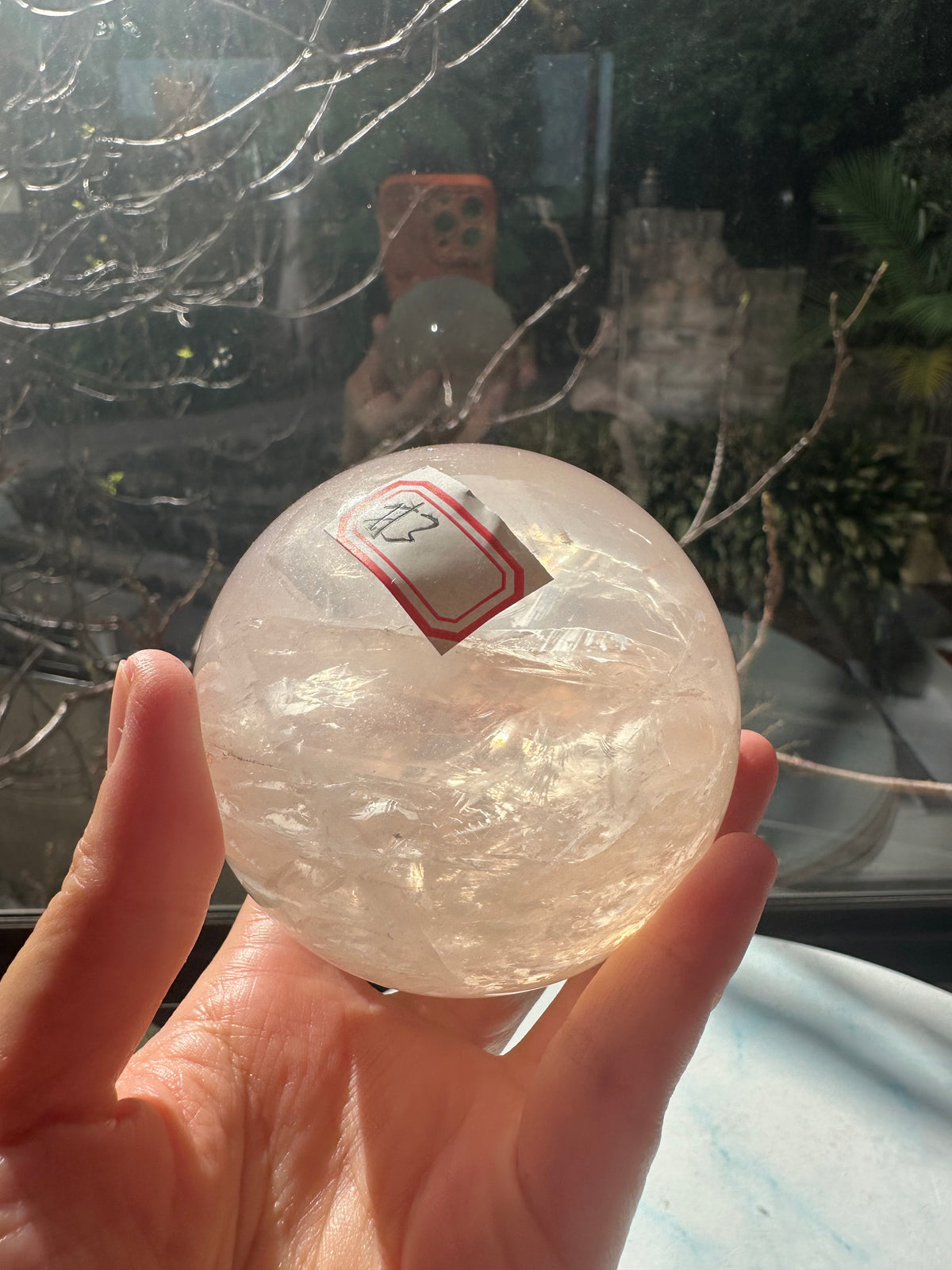 Fire Quartz sphere #3 showing red hematite inclusions and internal quartz veils, alternate view 13