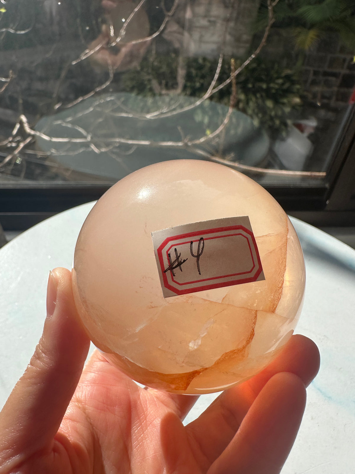 Fire Quartz sphere #4 showing red hematite inclusions and internal quartz veils, alternate view 2