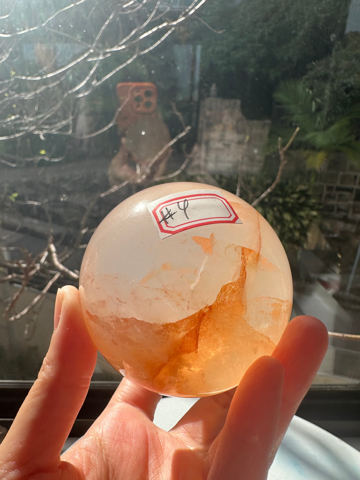 Fire Quartz sphere #4 showing red hematite inclusions and internal quartz veils, alternate view 3