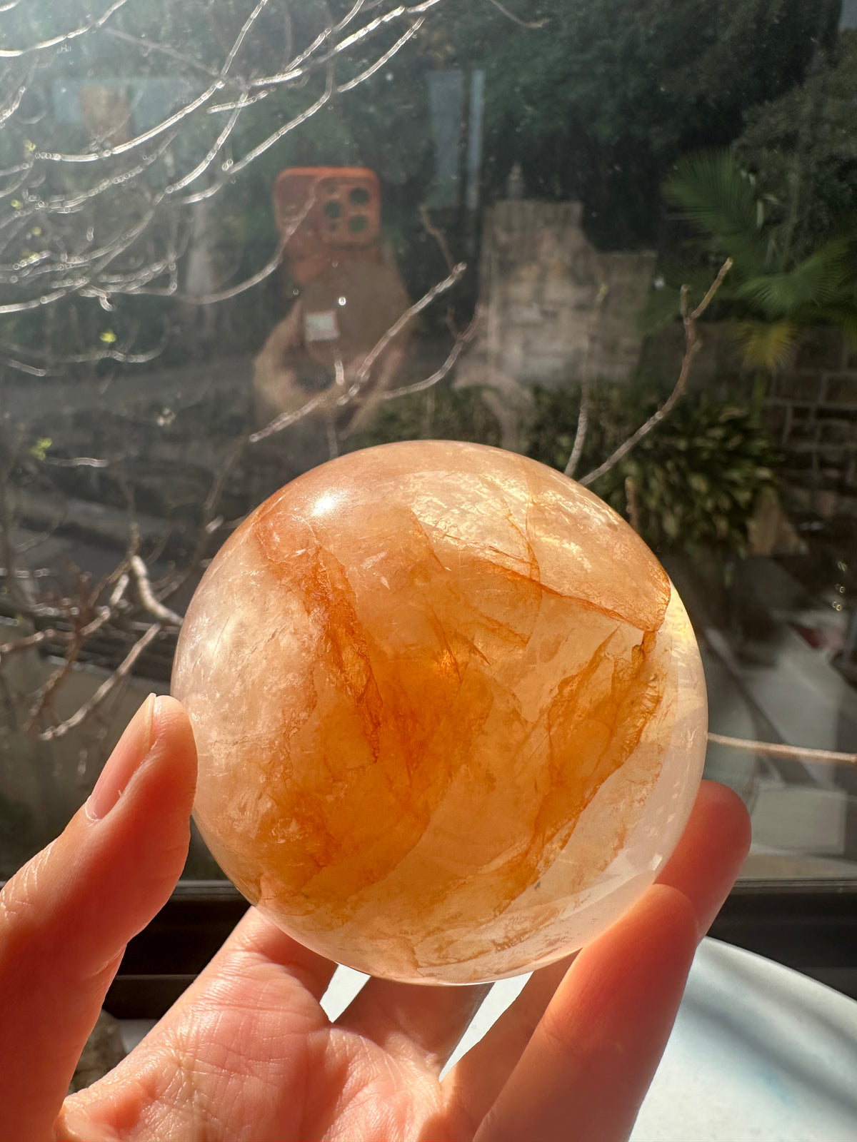 Fire Quartz sphere #4 showing red hematite inclusions and internal quartz veils, alternate view 4