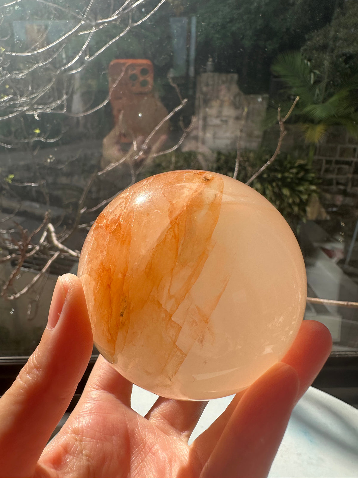Fire Quartz sphere #4 showing red hematite inclusions and internal quartz veils, alternate view 5