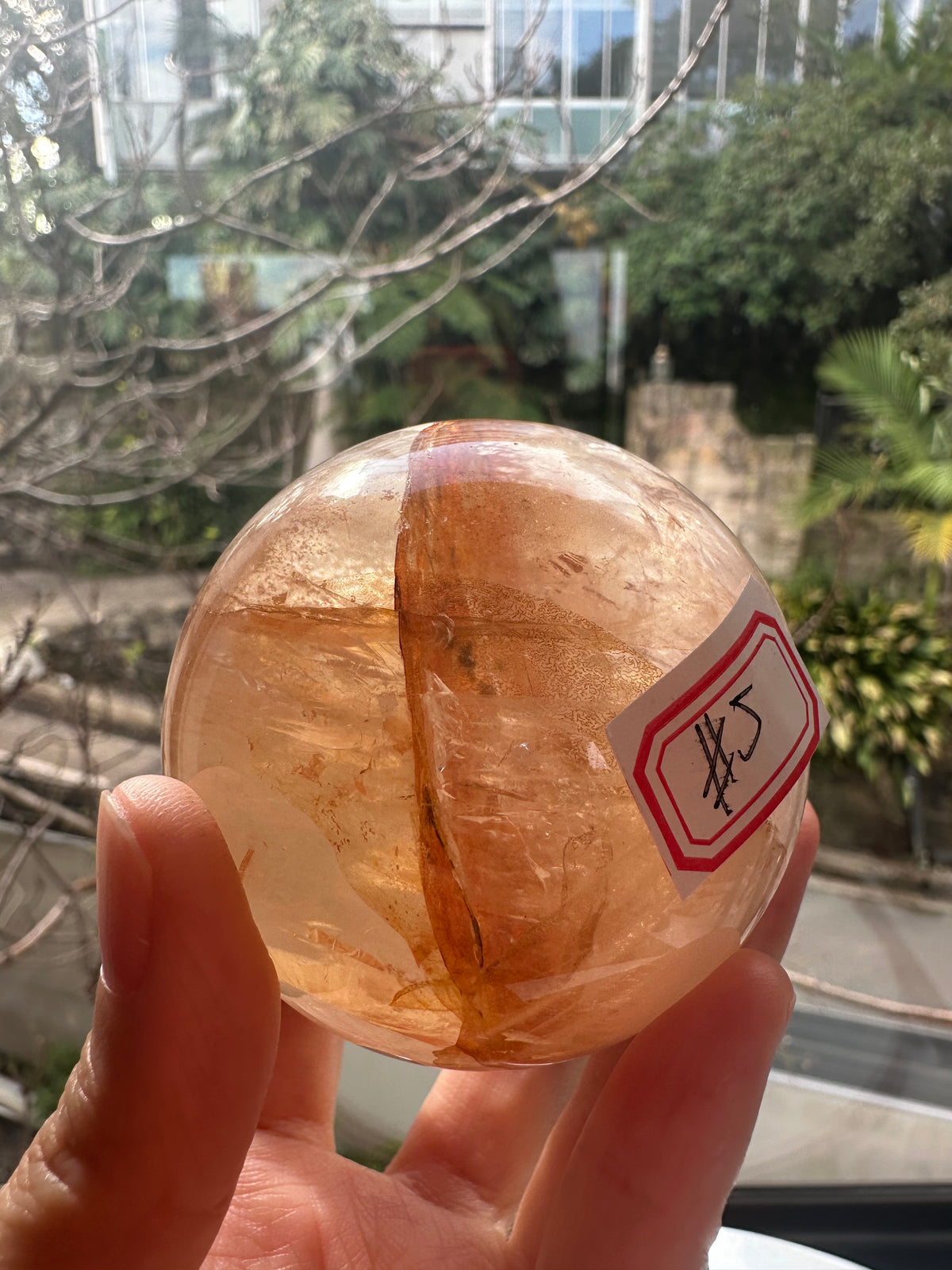 Fire Quartz sphere #5 showing red hematite inclusions and internal quartz veils, alternate view 3