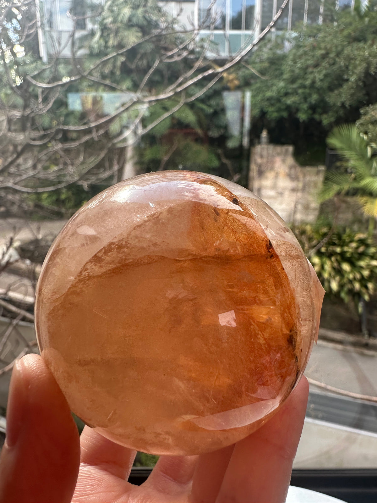 Fire Quartz sphere #5 showing red hematite inclusions and internal quartz veils, alternate view 4