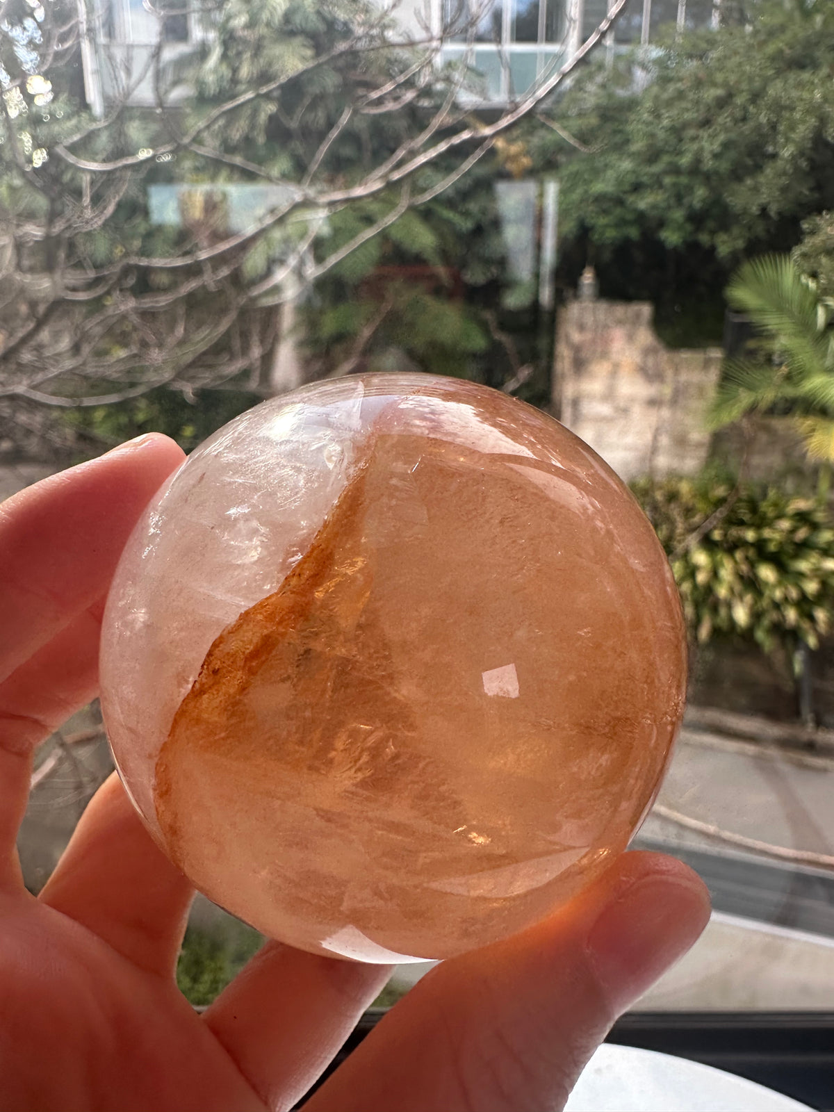Fire Quartz sphere #5 showing red hematite inclusions and internal quartz veils, alternate view 5