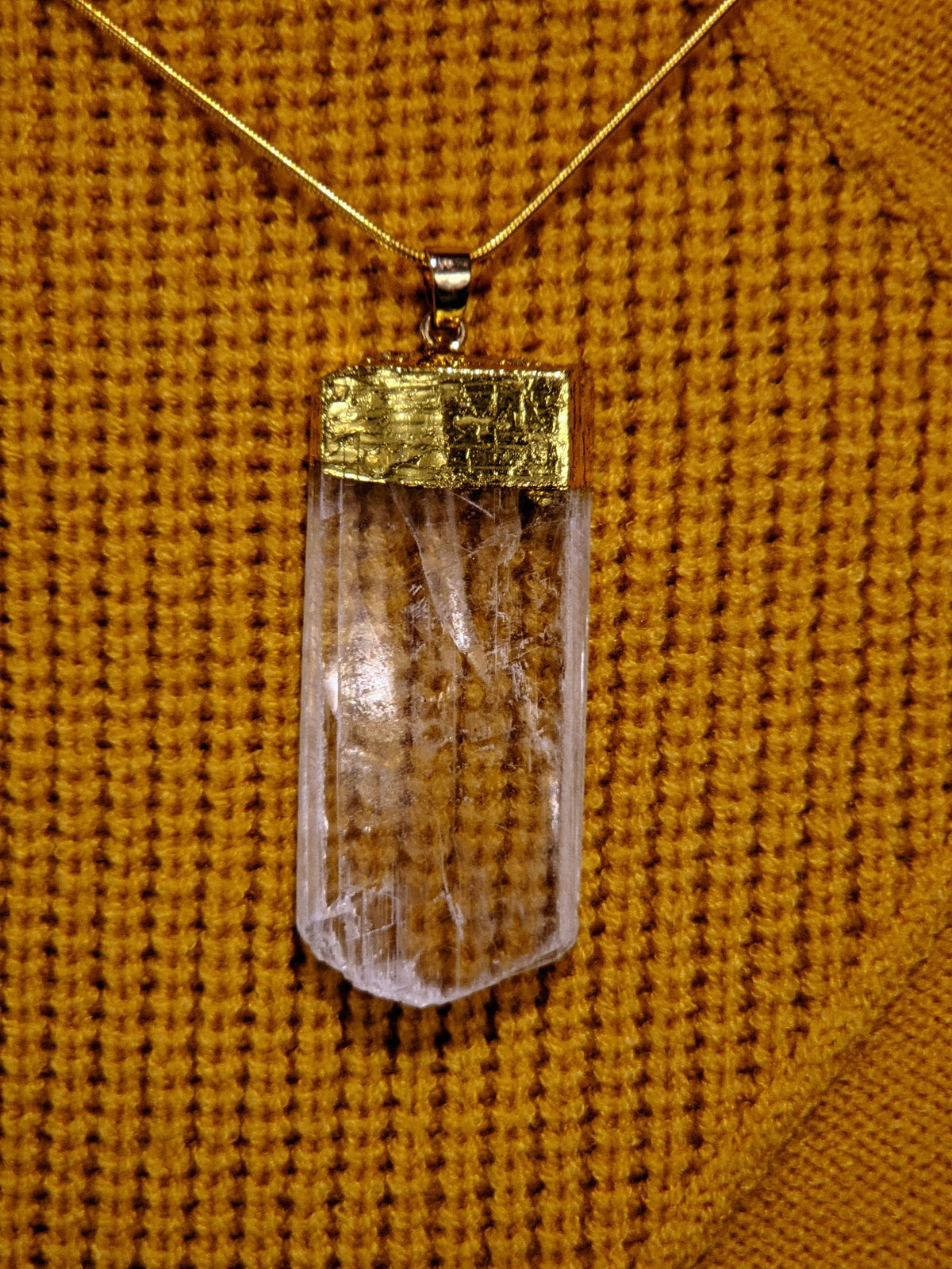 Selenite crystal pendant necklace detail showing smooth luminous finish