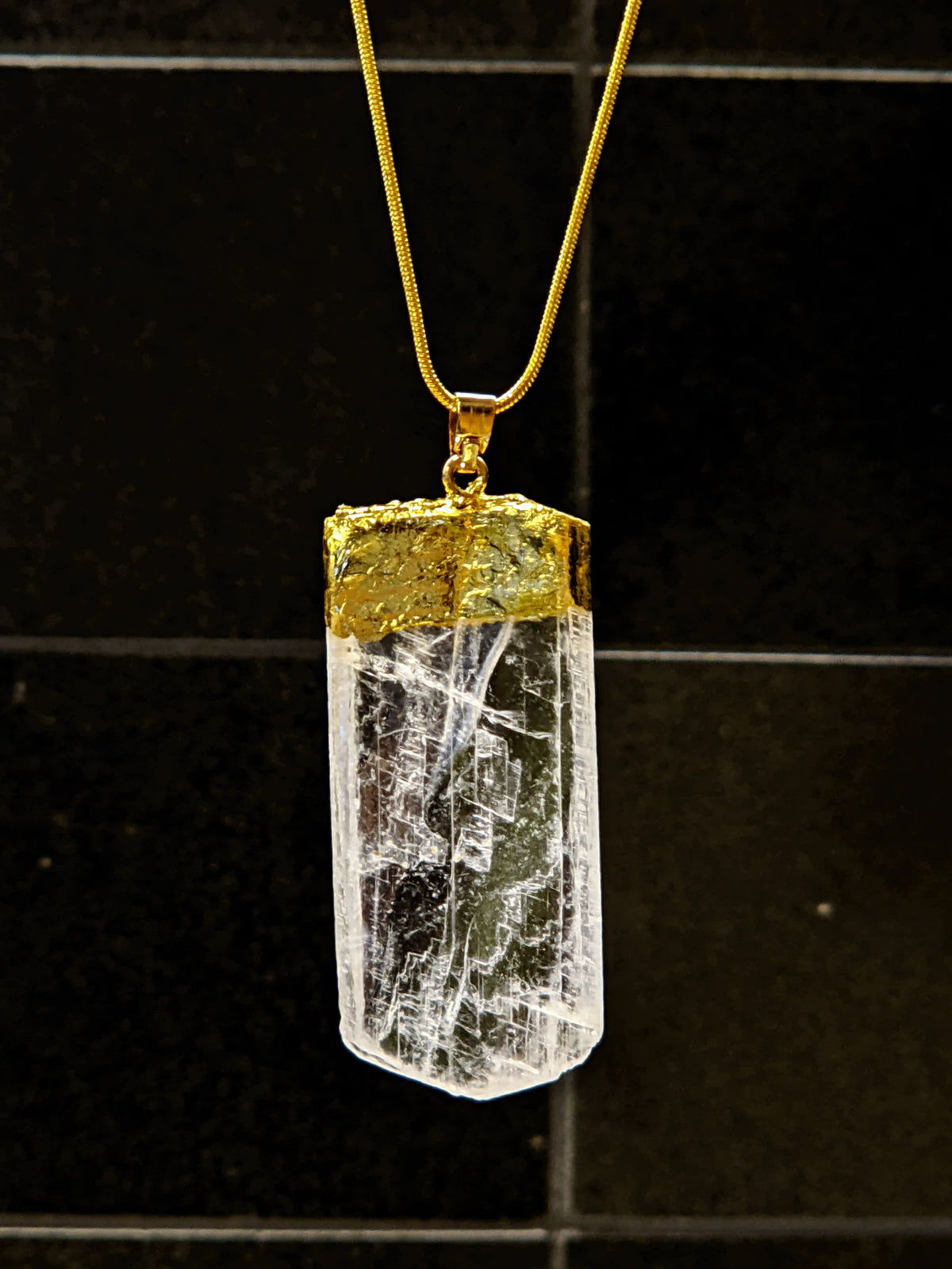 Selenite necklace product detail with polished crystal pendant and chain