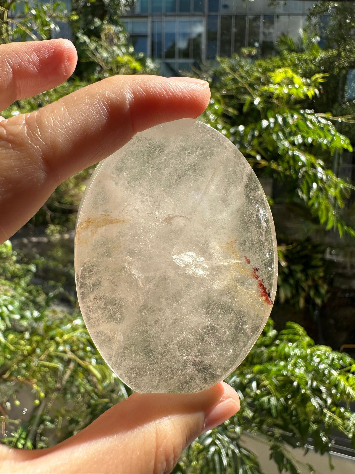 Natural polished Clear Quartz palm crystal close-up