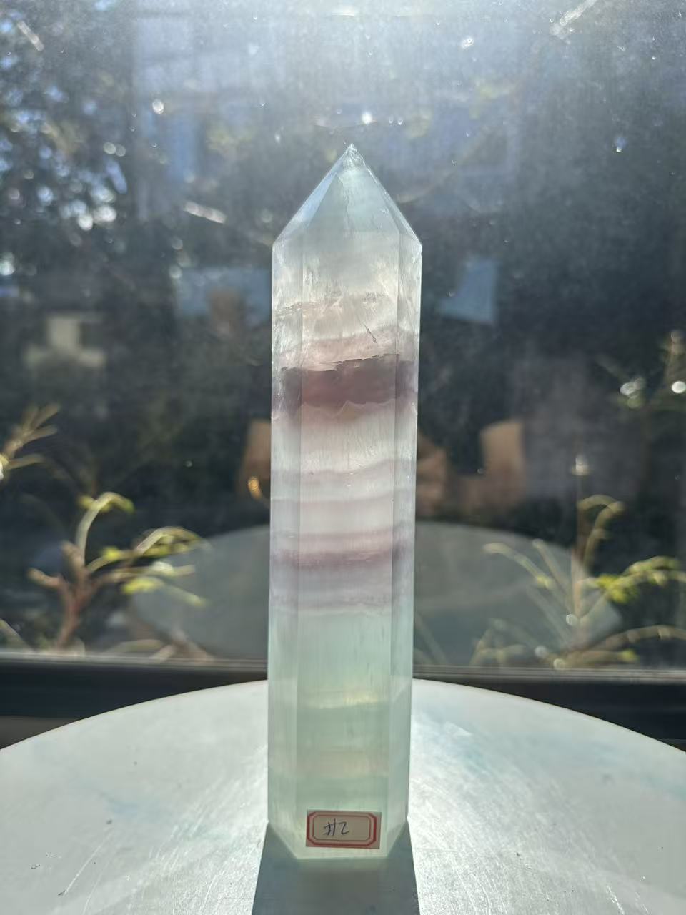  Hand-polished 22cm pale green fluorite pillar with rhythmic growth layers and a serene translucent finish, 1.1kg crystal decor for focused energy.