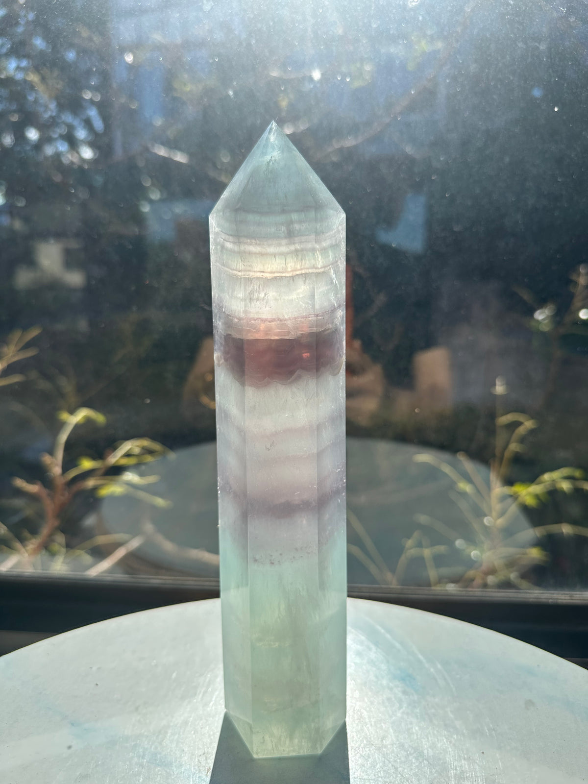  Hand-polished 22cm pale green fluorite pillar with rhythmic growth layers and a serene translucent finish, 1.1kg crystal decor for focused energy.