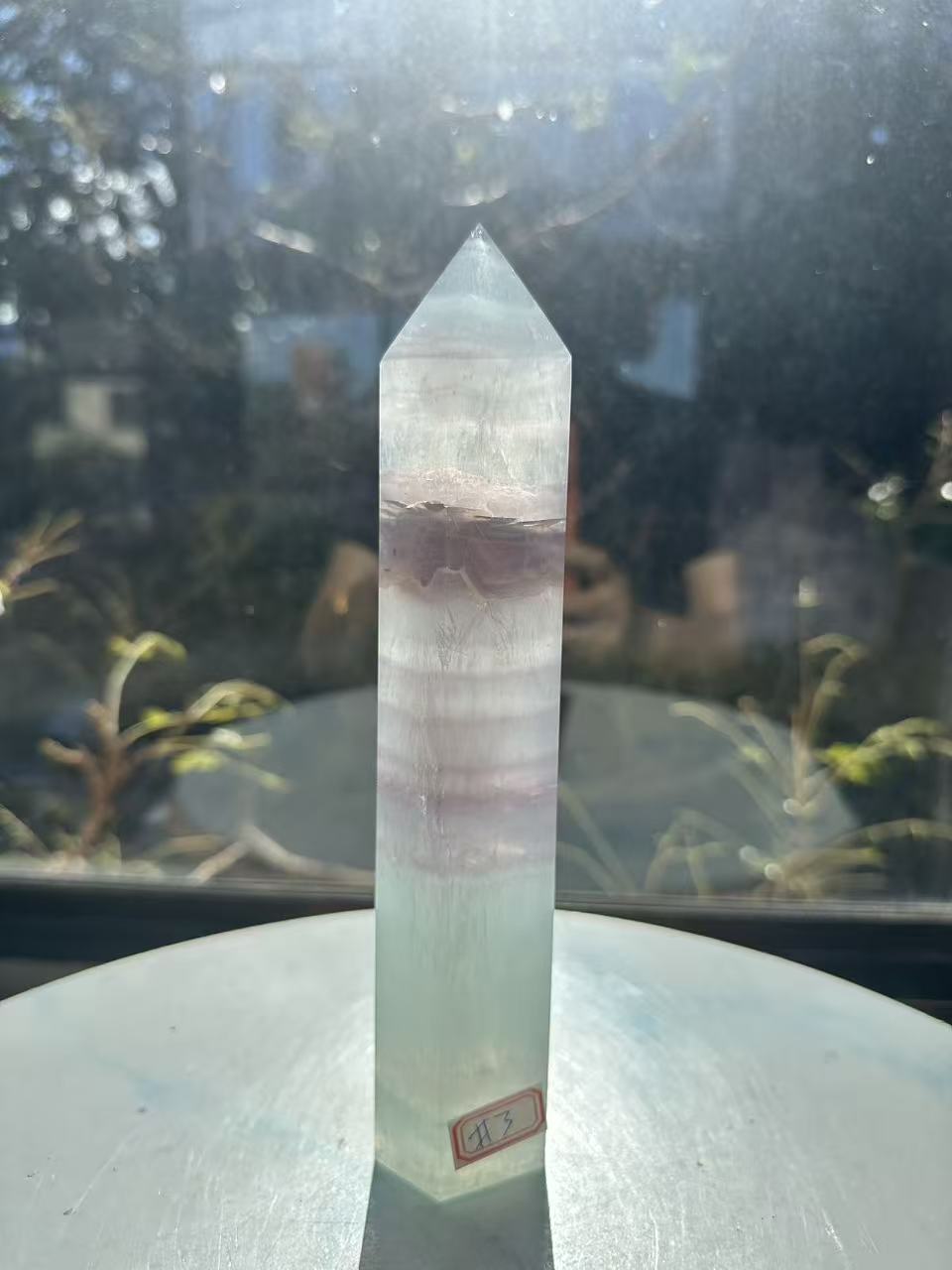 21cm rainbow fluorite tower showing intricate horizontal stripes and phantom structures in light green tones, a unique 0.846kg natural geometric mineral.