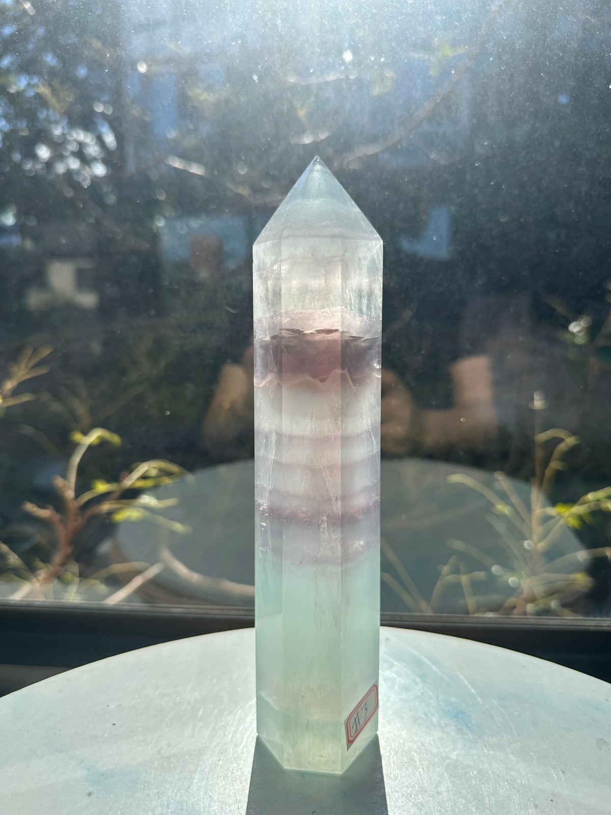 21cm rainbow fluorite tower showing intricate horizontal stripes and phantom structures in light green tones, a unique 0.846kg natural geometric mineral.