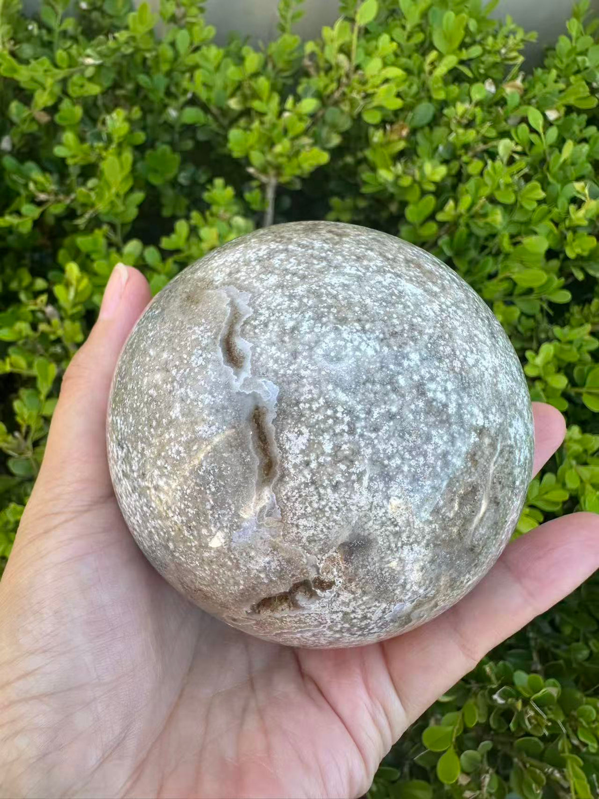 #3,"Large Moss Agate crystal sphere for professional desk decor, 772g, showing deep forest-like moss patterns and sparkling natural druzy by Moon Rituals."