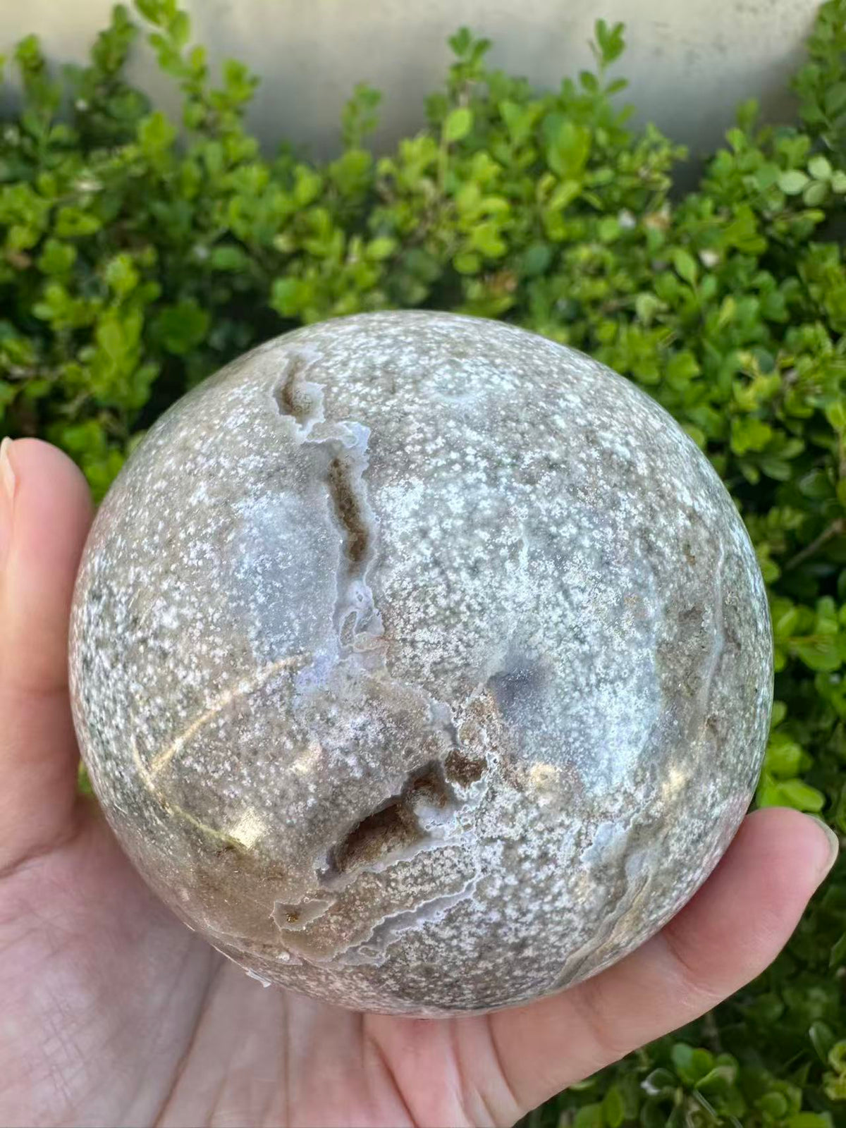 #3,"Large Moss Agate crystal sphere for professional desk decor, 772g, showing deep forest-like moss patterns and sparkling natural druzy by Moon Rituals."