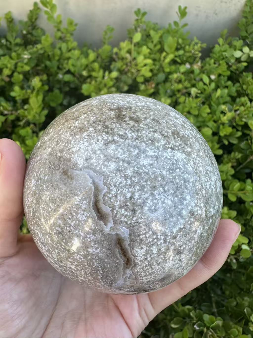 #3,"Large Moss Agate crystal sphere for professional desk decor, 772g, showing deep forest-like moss patterns and sparkling natural druzy by Moon Rituals."
