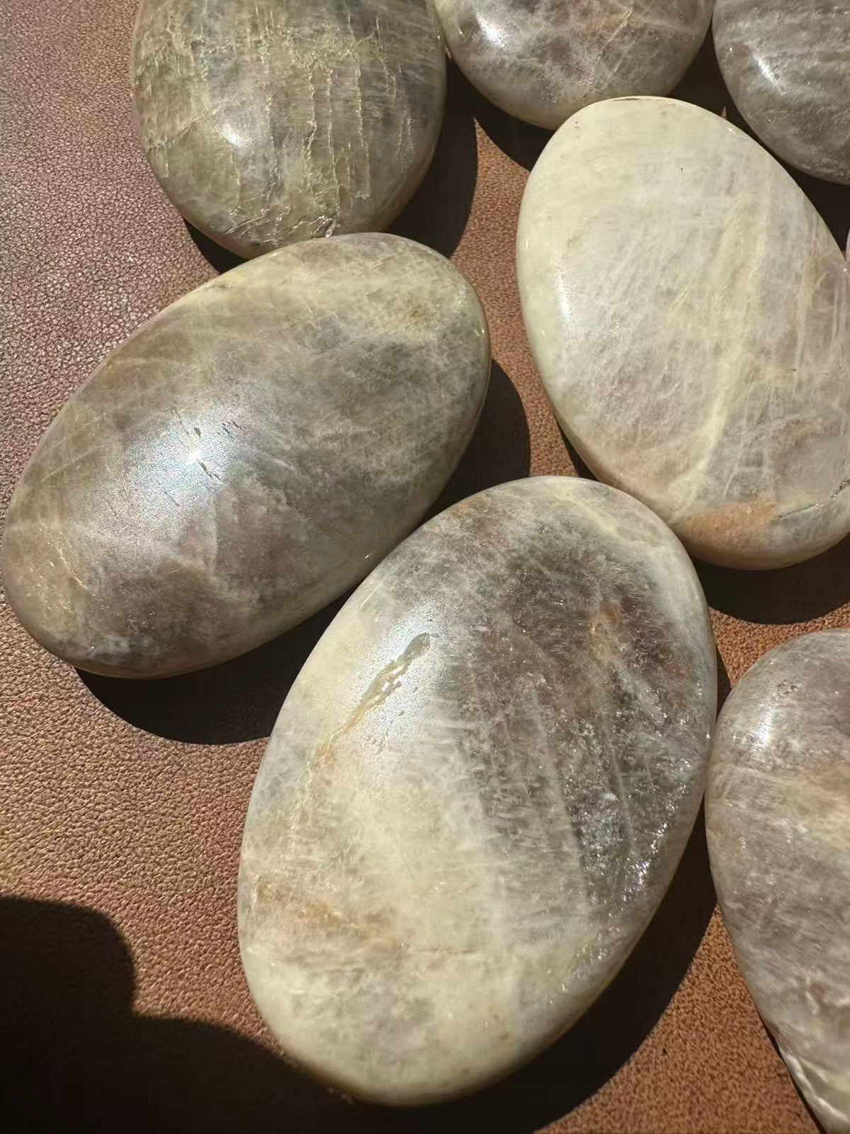 Rainbow Moonstone worry stone with smooth rounded shape and reflective flash
