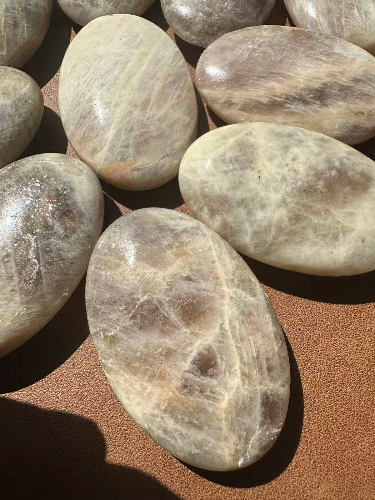 Rainbow Moonstone palm stone detail with natural blue and rainbow sheen
