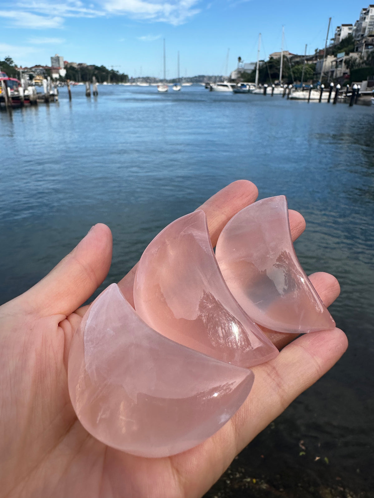 Polished Rose Quartz moon carving product view in soft pink stone