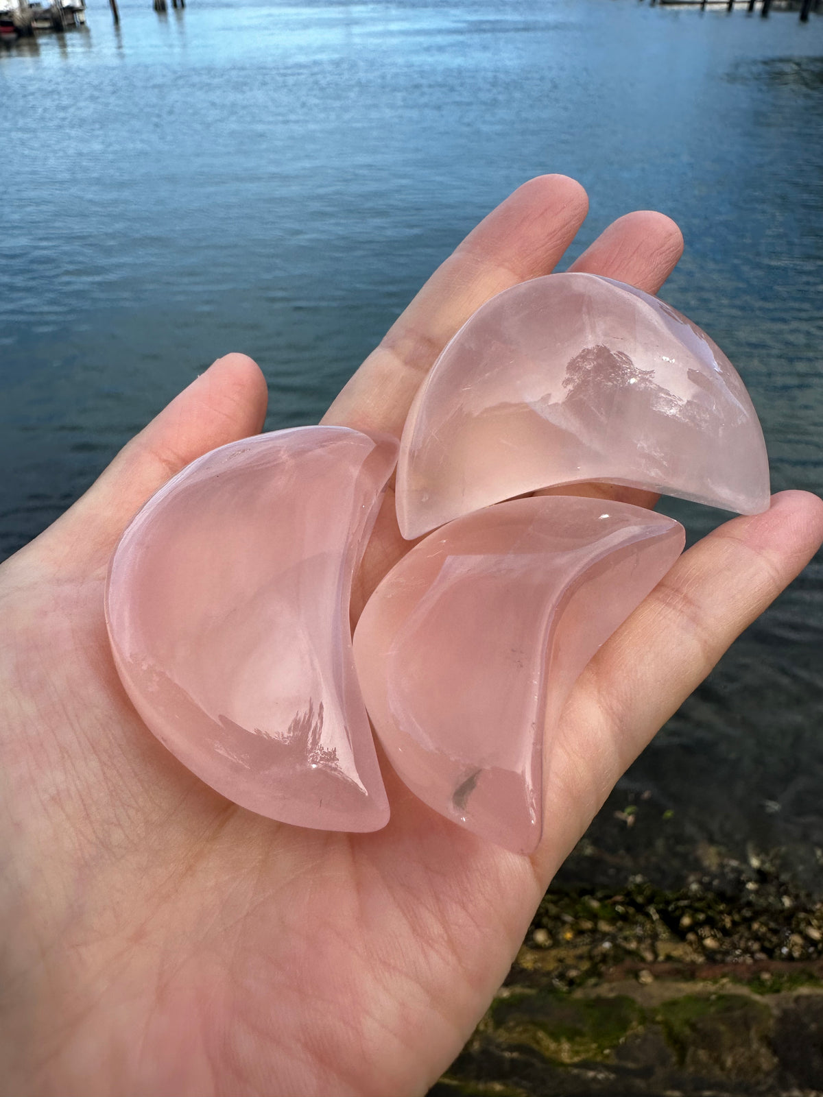 Natural Rose Quartz moon carving alternate view showing polished pink surface