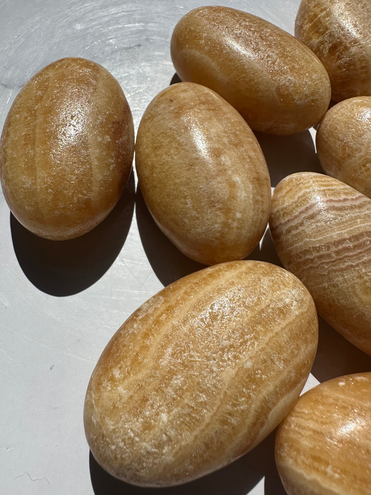 Polished Yellow Calcite worry stone showing natural banding